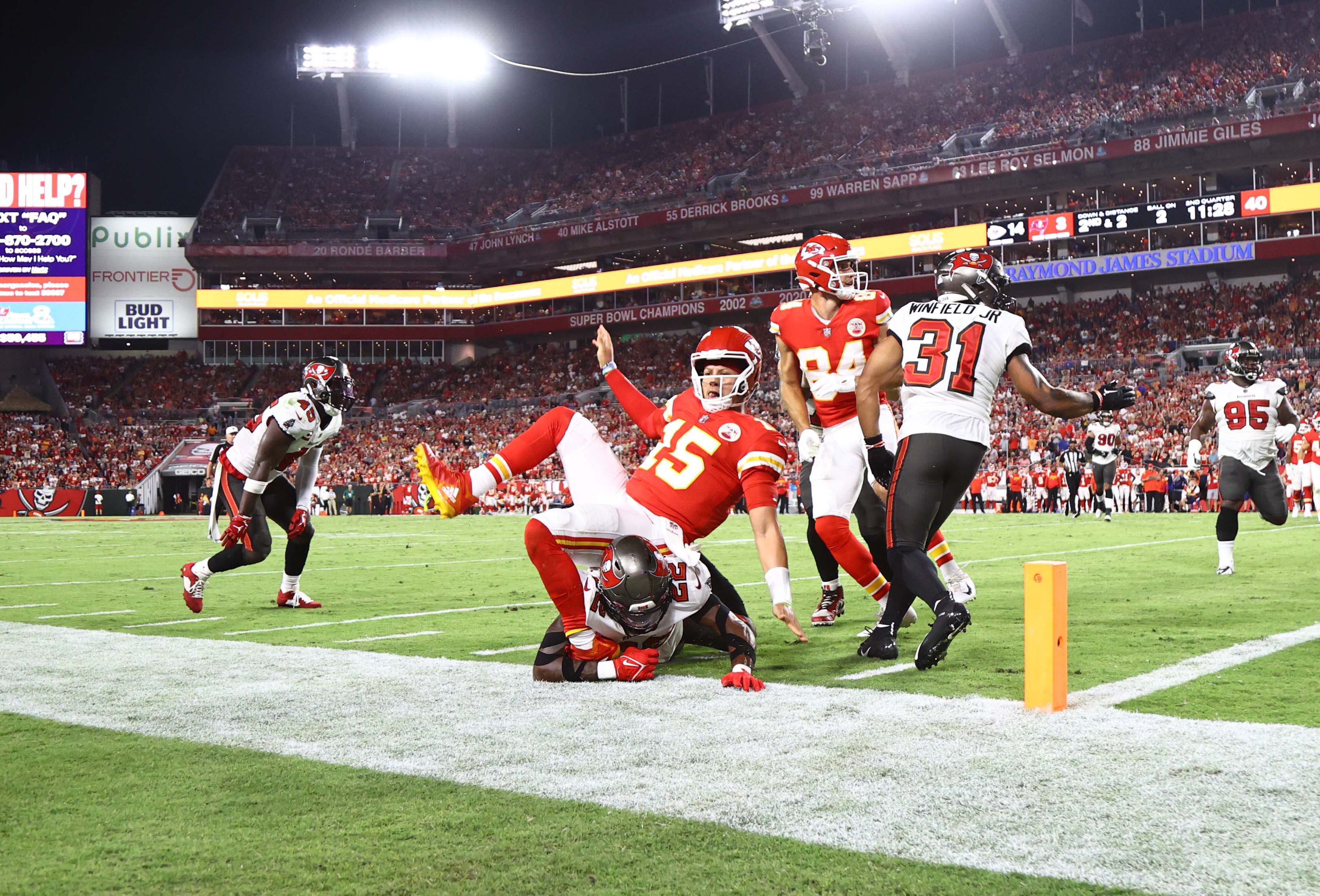 Chiefs quarterback Patrick Mahomes gets tripped up by Tampa Bay Buccaneers safety Keanu Neal.