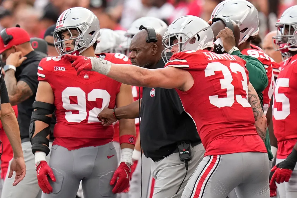 Ohio State Buckeyes defensive end Jack Sawyer (33) points out a play to coach Larry Johnson during the second half of the NCAA football game against the Akron Zips at Ohio Stadium. Ohio State won 52-6