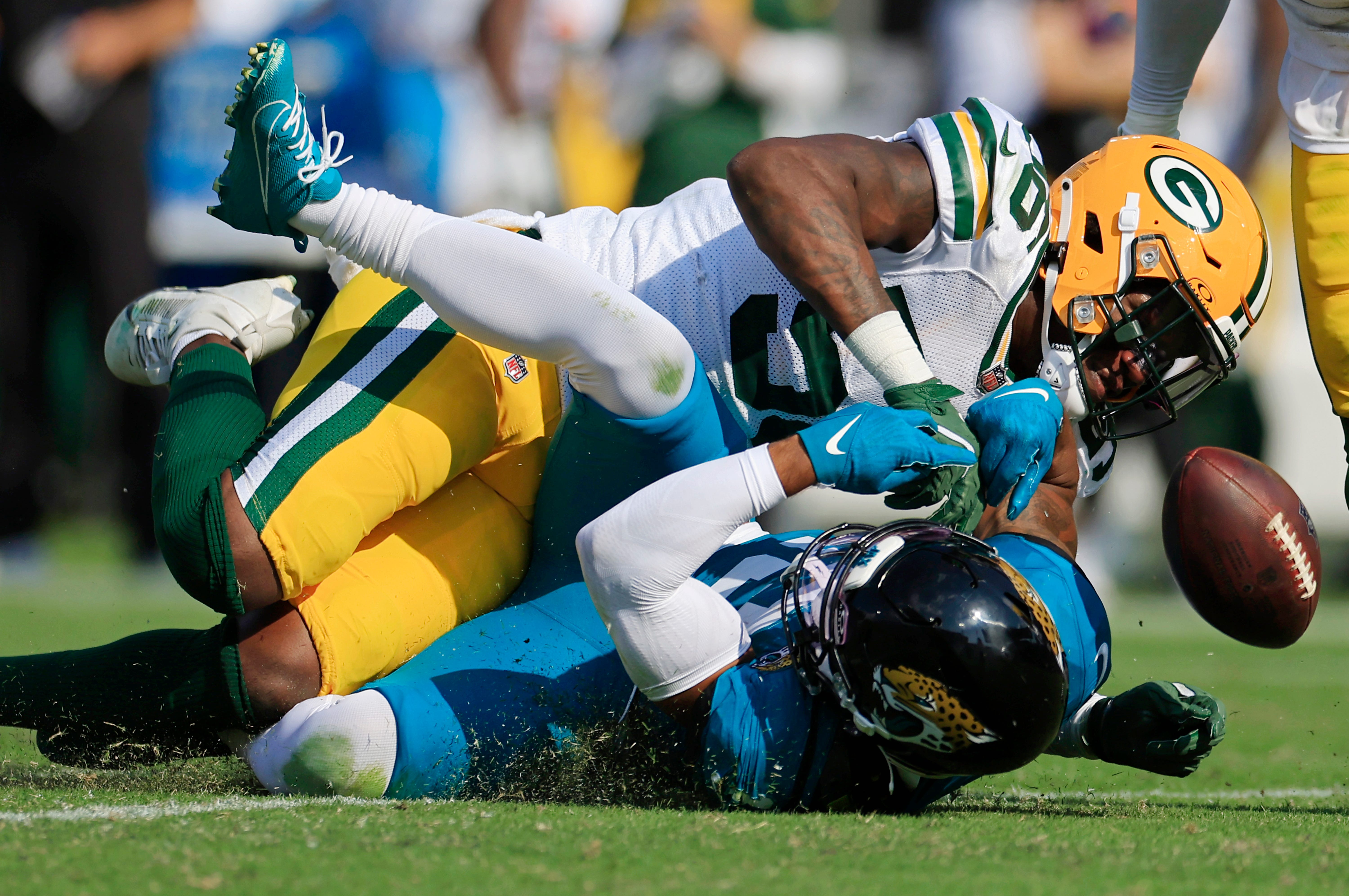 Green Bay Packers linebacker Edgerrin Cooper (56) tackles Jacksonville Jaguars wide receiver Christian Kirk (13) who can’t hang on to a pass and was apparently injured on the play and had to leave the game during the fourth quarter of an NFL football matchup Sunday, Oct. 27, 2024 at EverBank Stadium in Jacksonville, Fla. The Packers edged the Jaguars 30-27 on a last-second field goal.