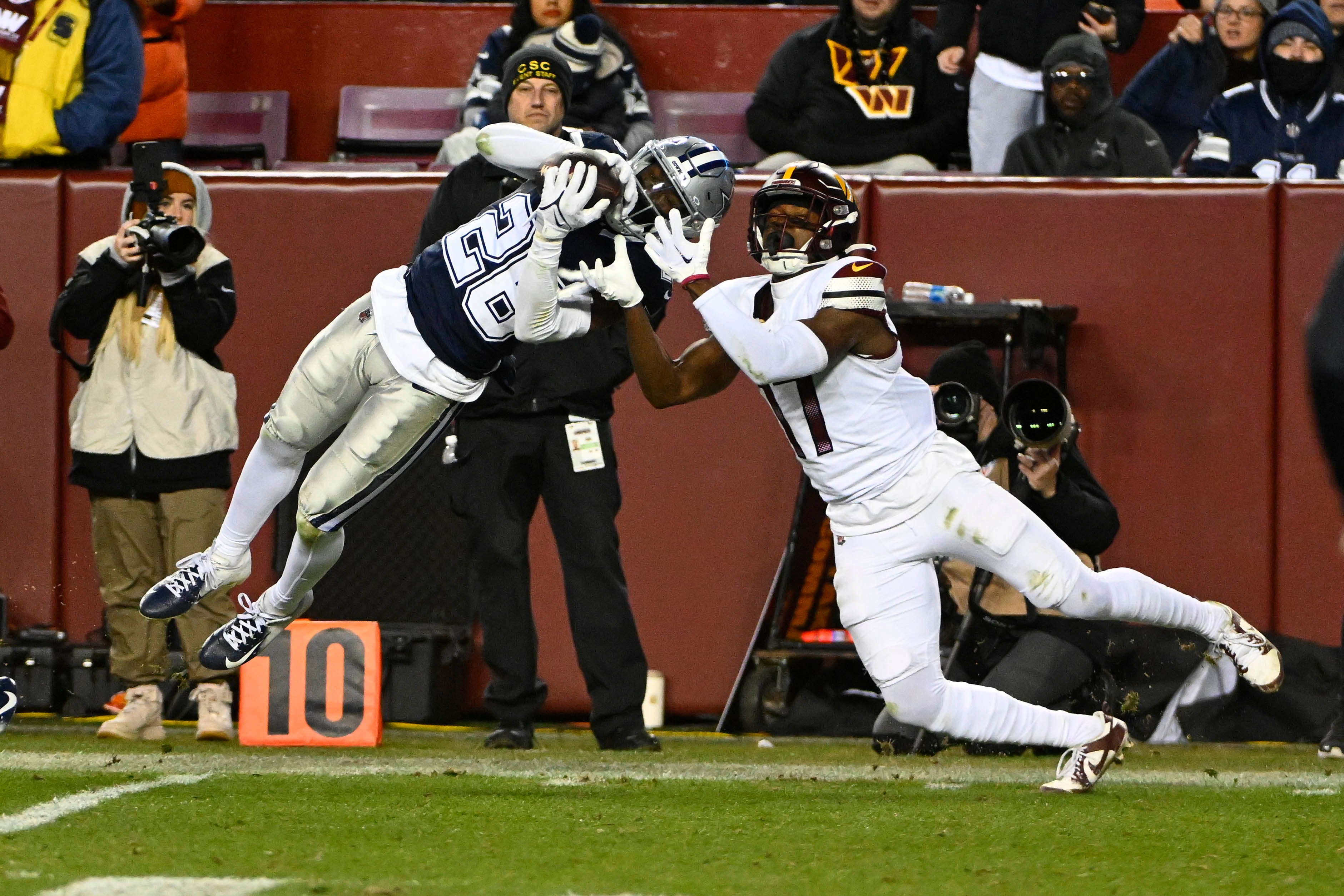 Jan 7, 2024; Landover, Maryland, USA; Dallas Cowboys cornerback DaRon Bland (26) intercepts a pass intended for Washington Commanders wide receiver Terry McLaurin (17) during the second half at FedExField.