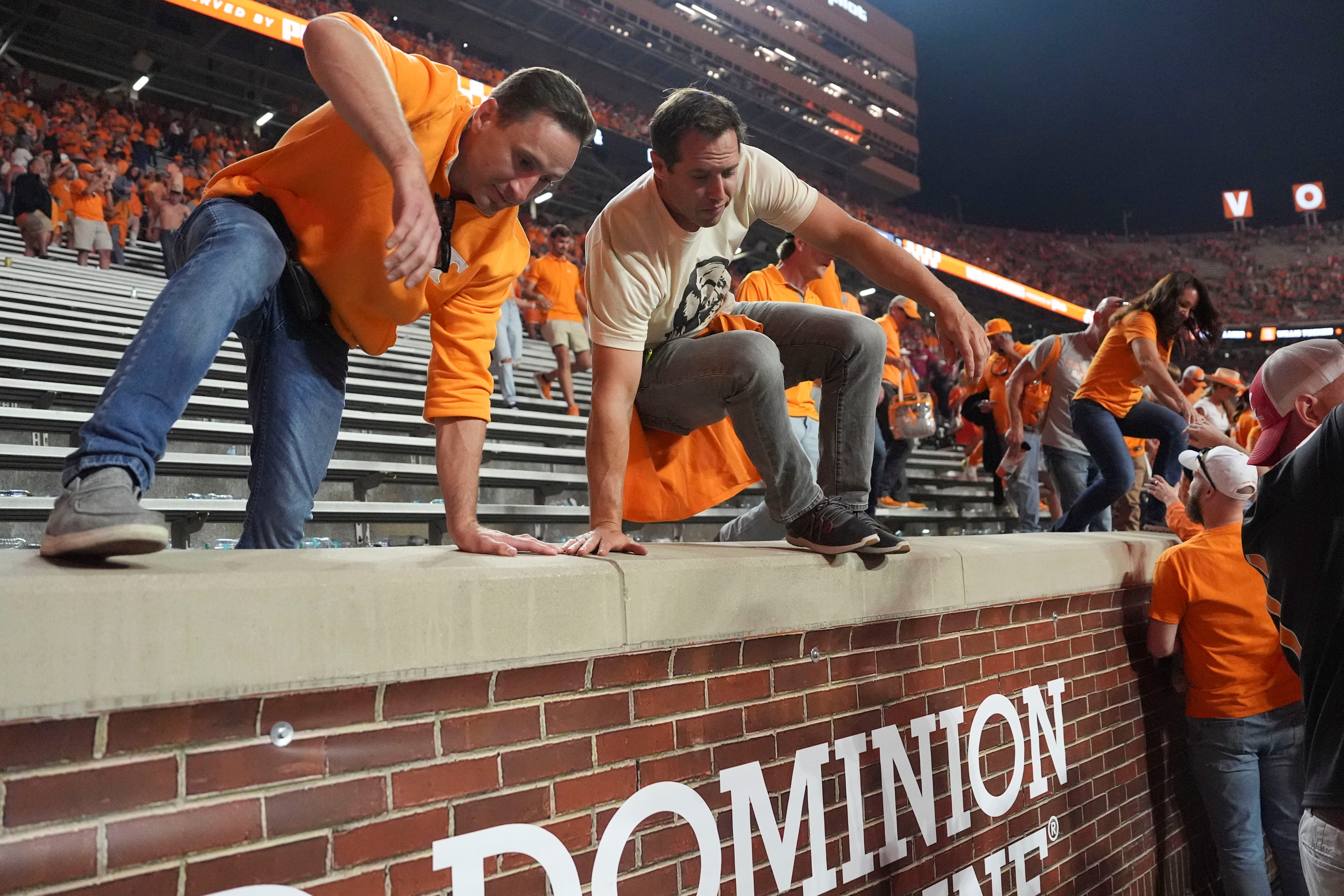 Fans leap onto the field after Tennessee's win over Alabama in an NCAA college football game on Saturday, Oct. 19, 2024, in Knoxville. Tenn.