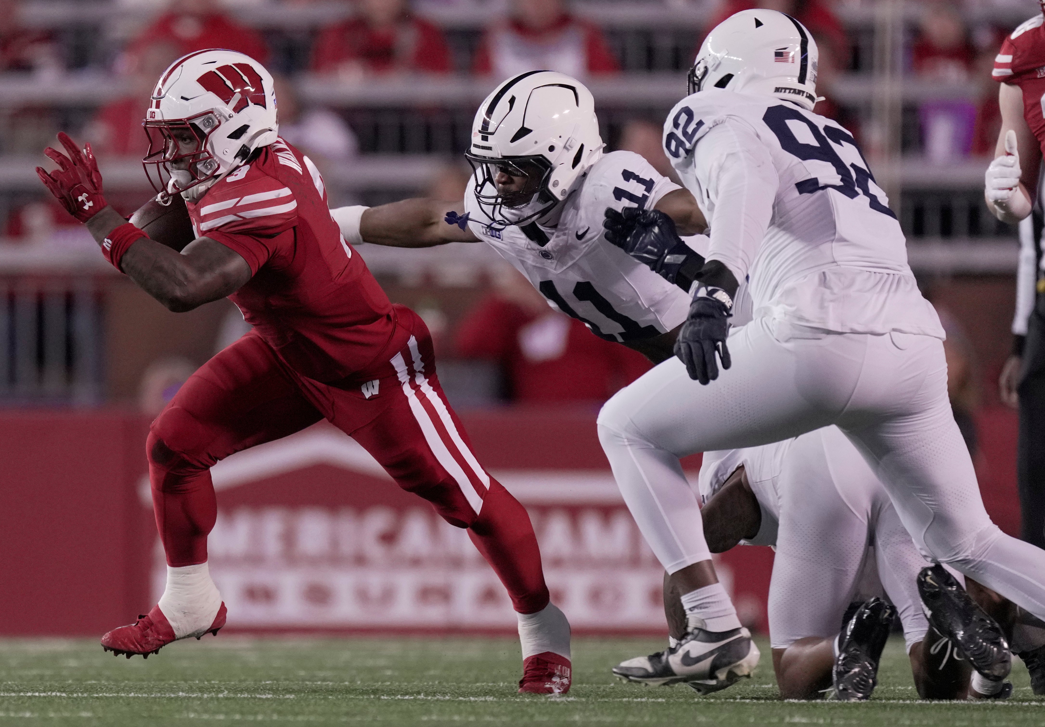 Wisconsin Badgers running back Tawee Walker (3) is chased by Penn State Nittany Lions defensive end Abdul Carter (11) during the first quarter at Camp Randall Stadium.