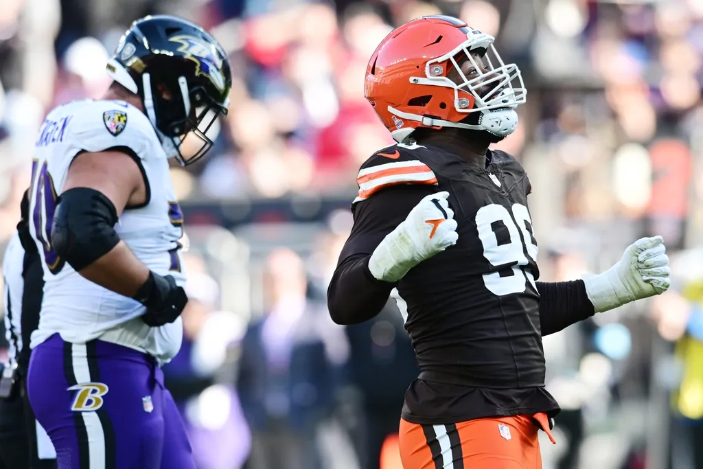 Cleveland Browns defensive end Za'Darius Smith (99) celebrates after sacking Baltimore Ravens quarterback Lamar Jackson (8) during the second half at Huntington Bank Field.