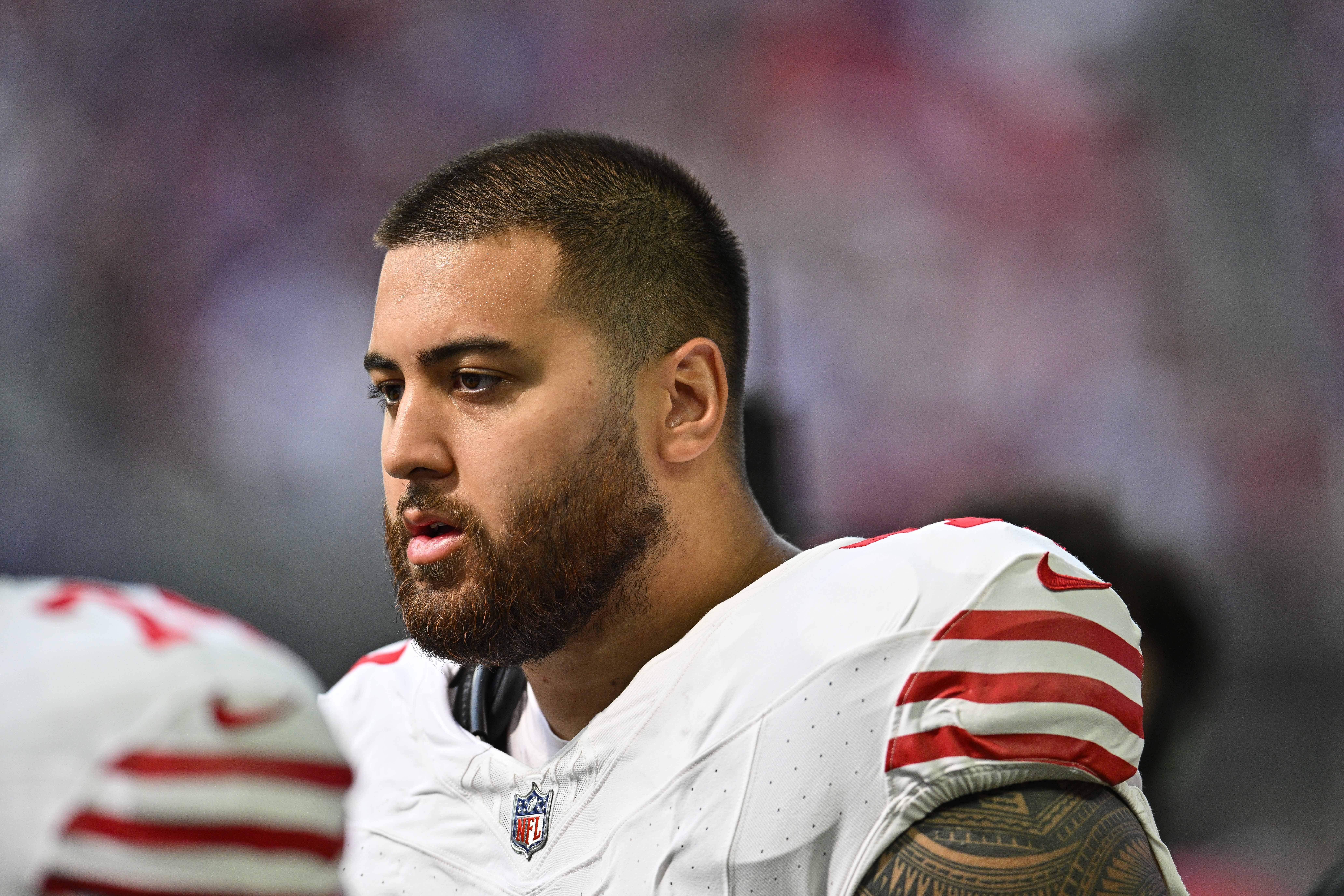 San Francisco 49ers guard Dominick Puni (77) looks on during the game against the Minnesota Vikings at U.S. Bank Stadium.