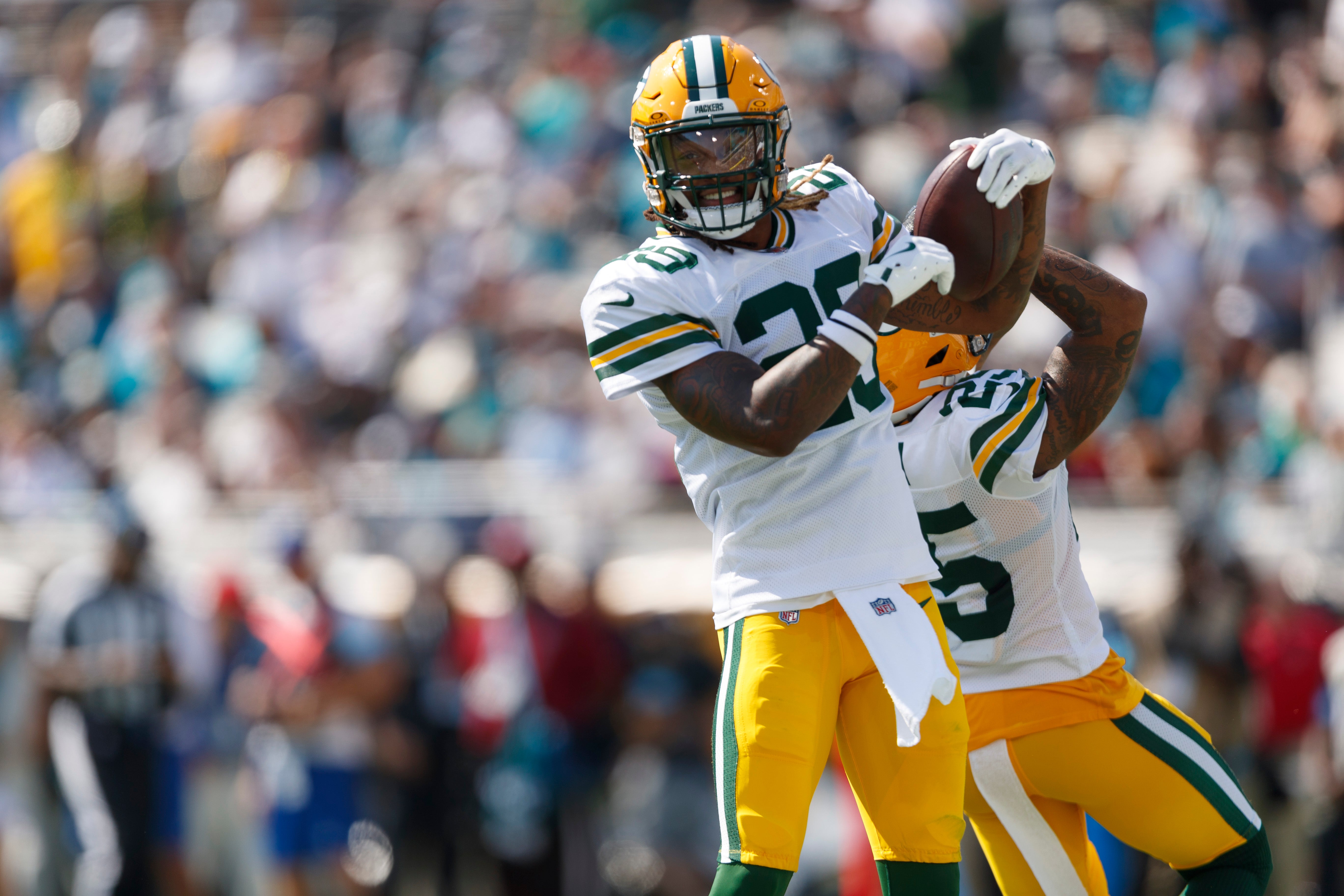 Green Bay Packers safety Xavier McKinney (29) and cornerback Keisean Nixon (25) celebrate an interception against the Jacksonville Jaguars during the second quarter at EverBank Stadium.