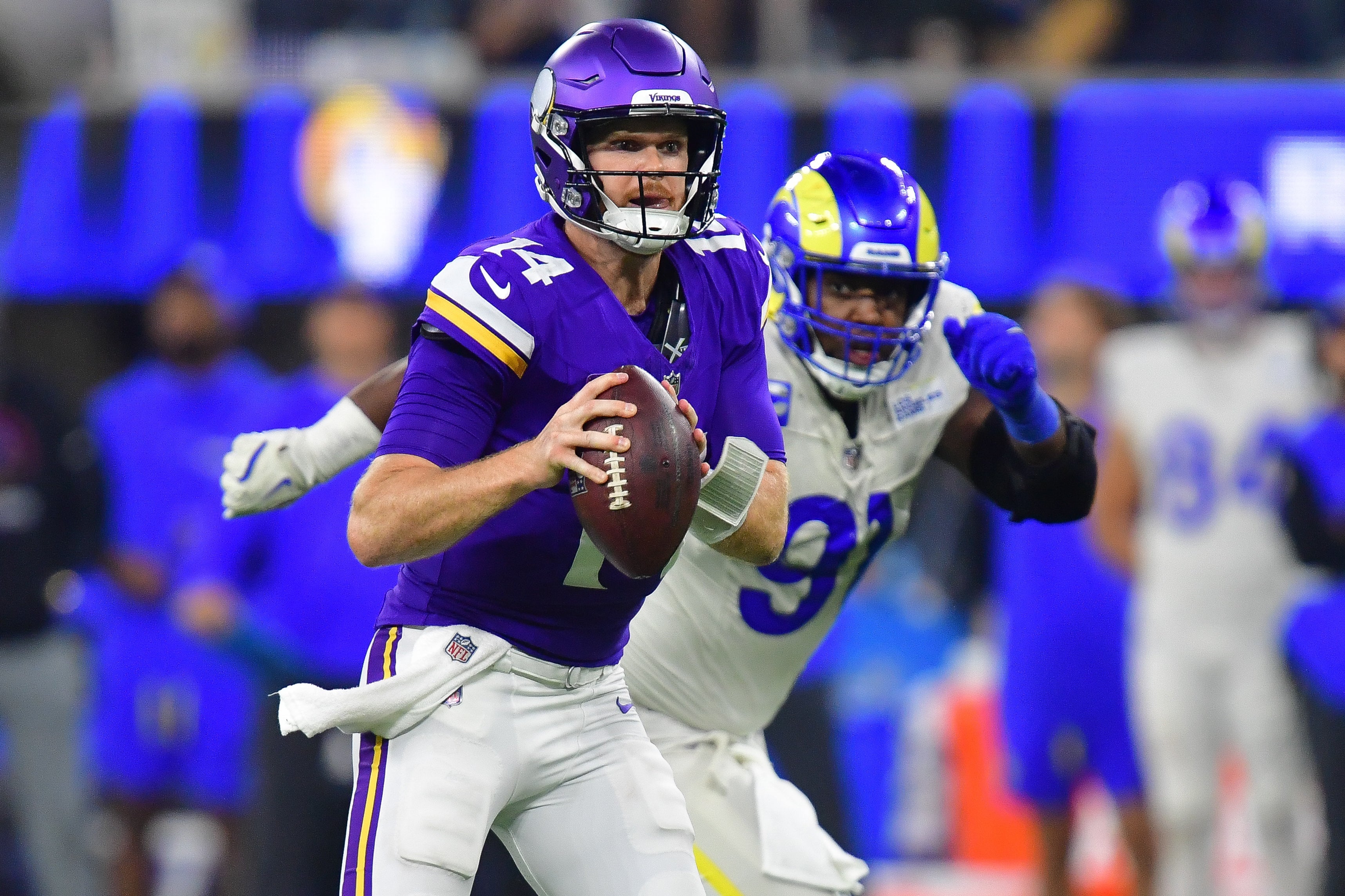 Oct 24, 2024; Inglewood, California, USA; Minnesota Vikings quarterback Sam Darnold (14) runs the ball ahead of Los Angeles Rams defensive tackle Kobie Turner (91) during the second half at SoFi Stadium.