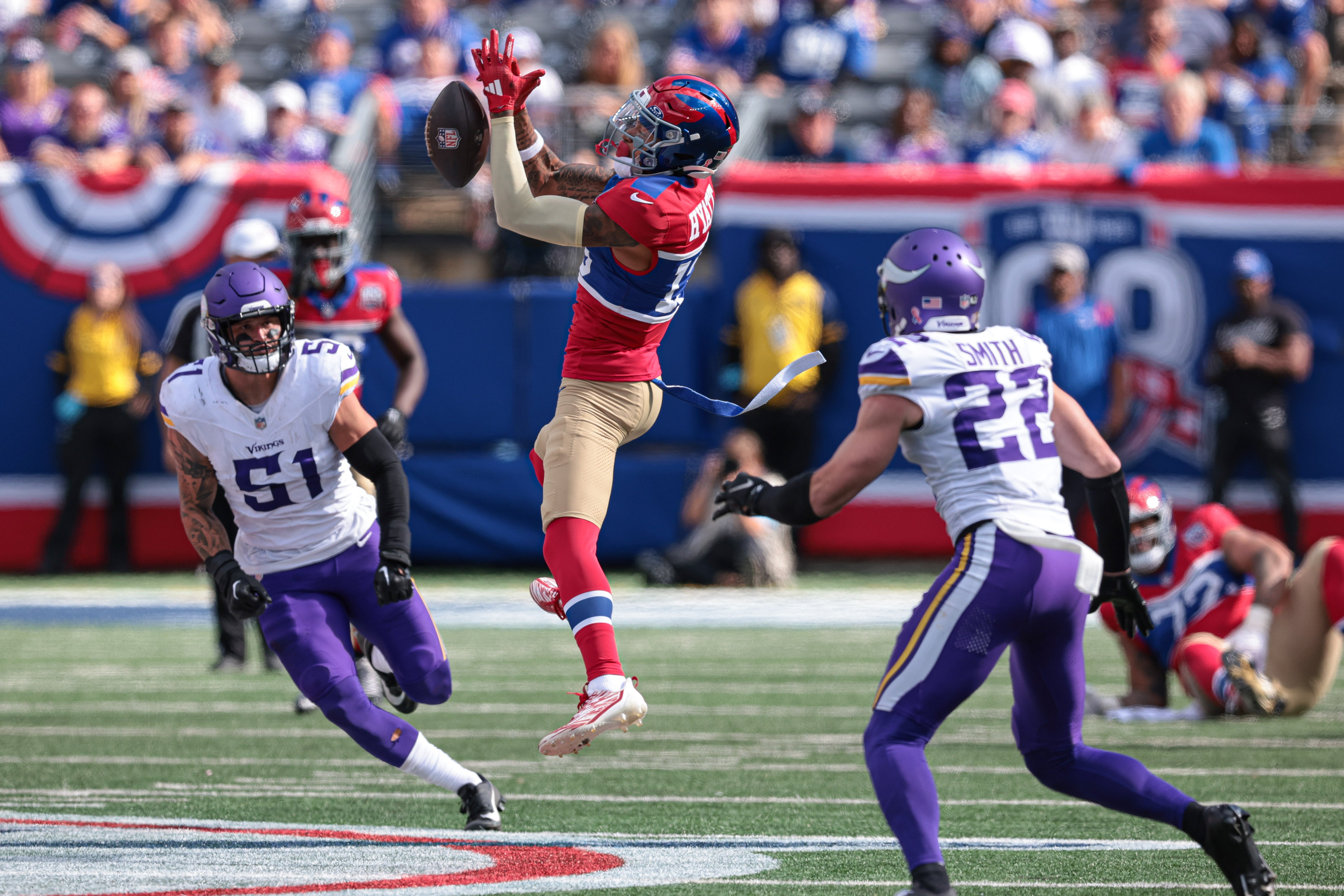 Sep 8, 2024; East Rutherford, New Jersey, USA; New York Giants wide receiver Jalin Hyatt (13) can not hold on to the ball in front of Minnesota Vikings linebacker Blake Cashman (51) and safety Harrison Smith (22) during the second half at MetLife Stadium.