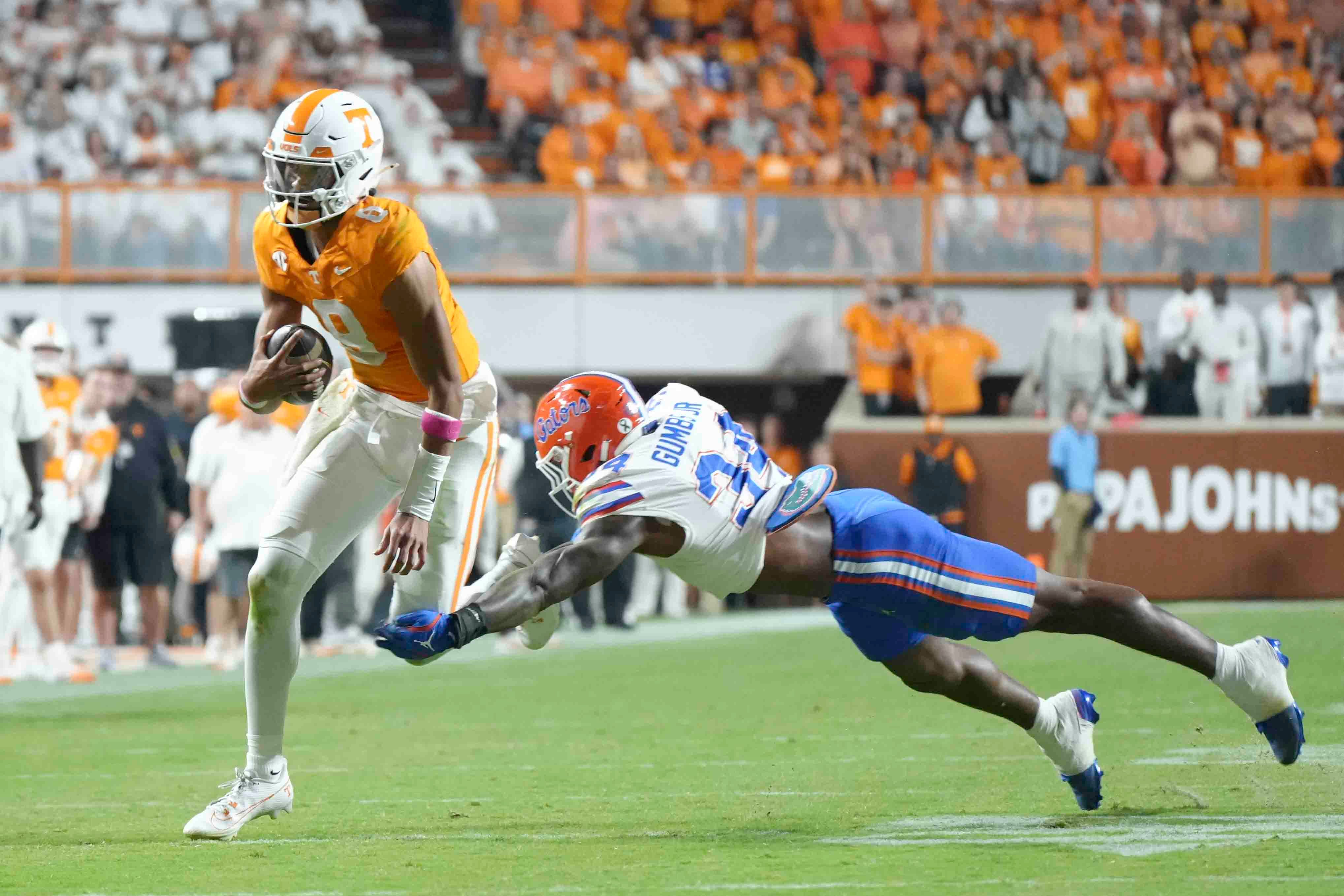 Tennessee quarterback Nico Iamaleava (8) is defended by Florida edge George Gumbs Jr. (34) during a game between Florida and Tennessee in Neyland Stadium, in Knoxville, Tenn., Saturday, Oct. 12, 2024.