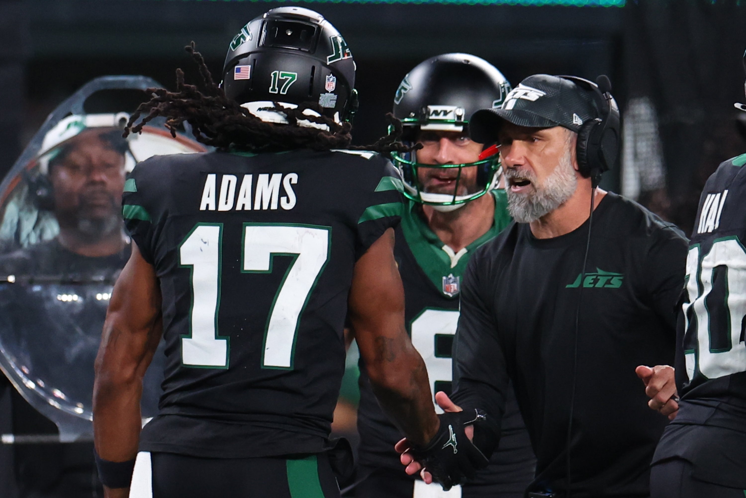 New York Jets wide receiver Davante Adams (17), quarterback Aaron Rodgers (8) and interim head coach Jeff Ulbrich celebrate Adams touchdown against the Houston Texans during the second half at MetLife Stadium.