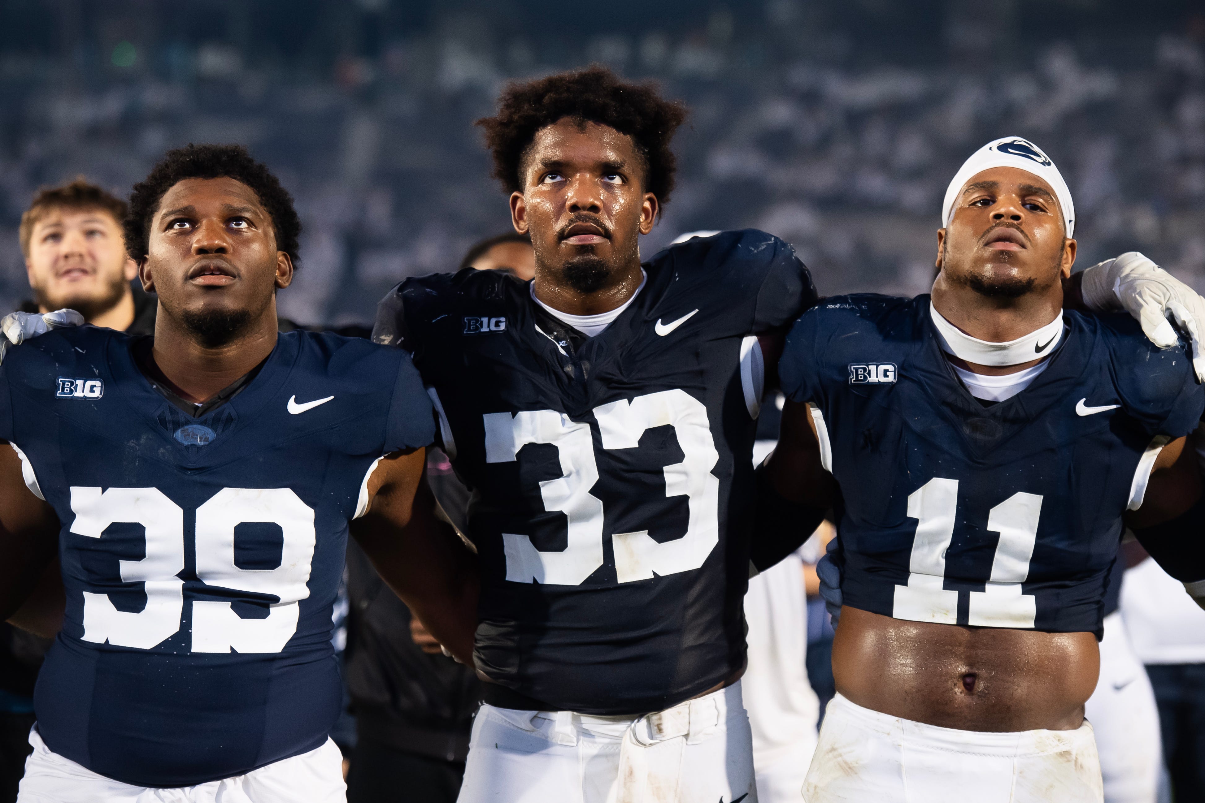 Penn State defensive players Ty Blanding (39), Dani Dennis-Sutton (33) and Abdul Carter (11) come together during the alma mater following a Big Ten football game against Illinois, Saturday, Sept. 28, 2024, in State College, Pa.