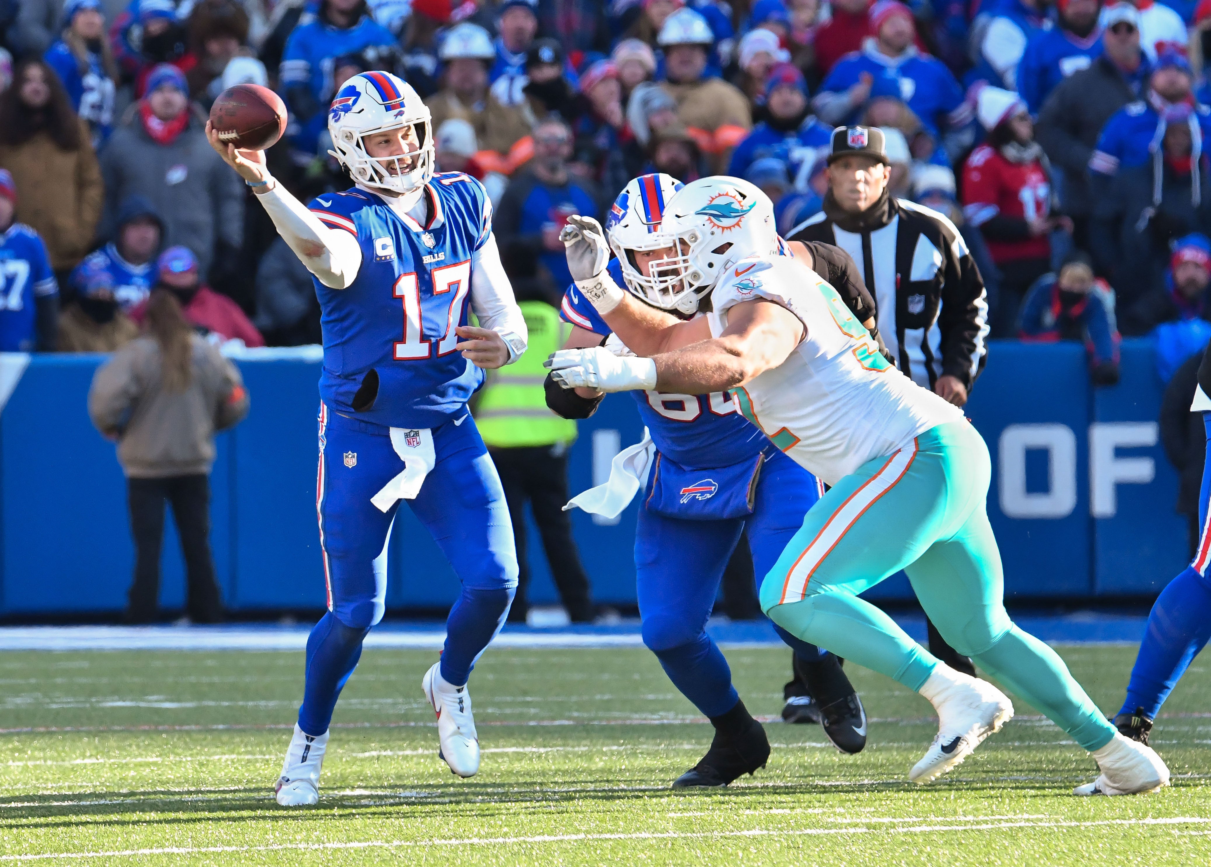Jan 15, 2023; Orchard Park, New York, USA; Buffalo Bills quarterback Josh Allen (17) throws a pass against Miami Dolphins defensive tackle Zach Sieler (92) in the second quarter of a wild card game at Highmark Stadium.