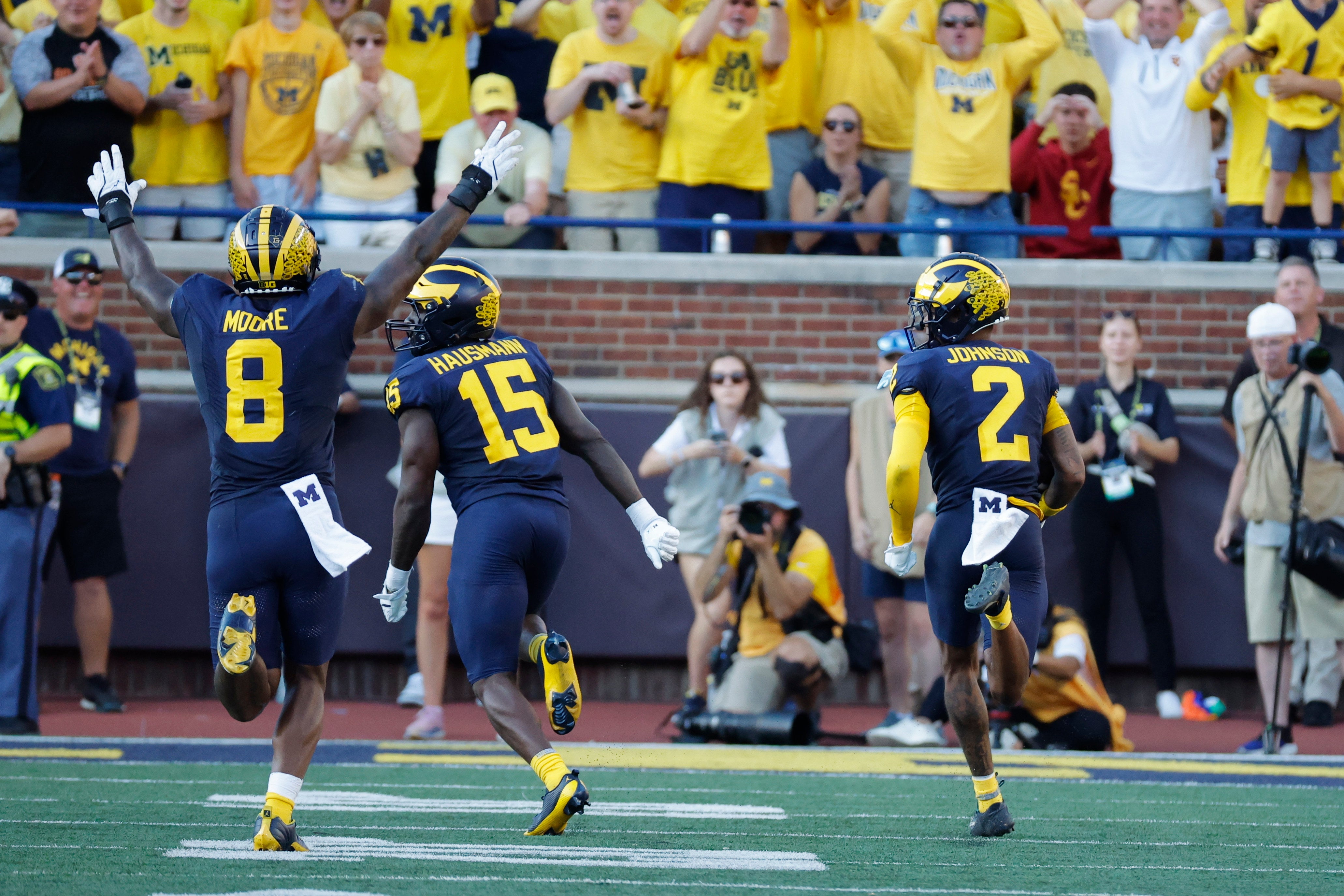Sep 21, 2024; Ann Arbor, Michigan, USA; Michigan Wolverines defensive back Will Johnson (2) runs the ball for a touchdown after he makes an interception against the USC Trojans at Michigan Stadium.
