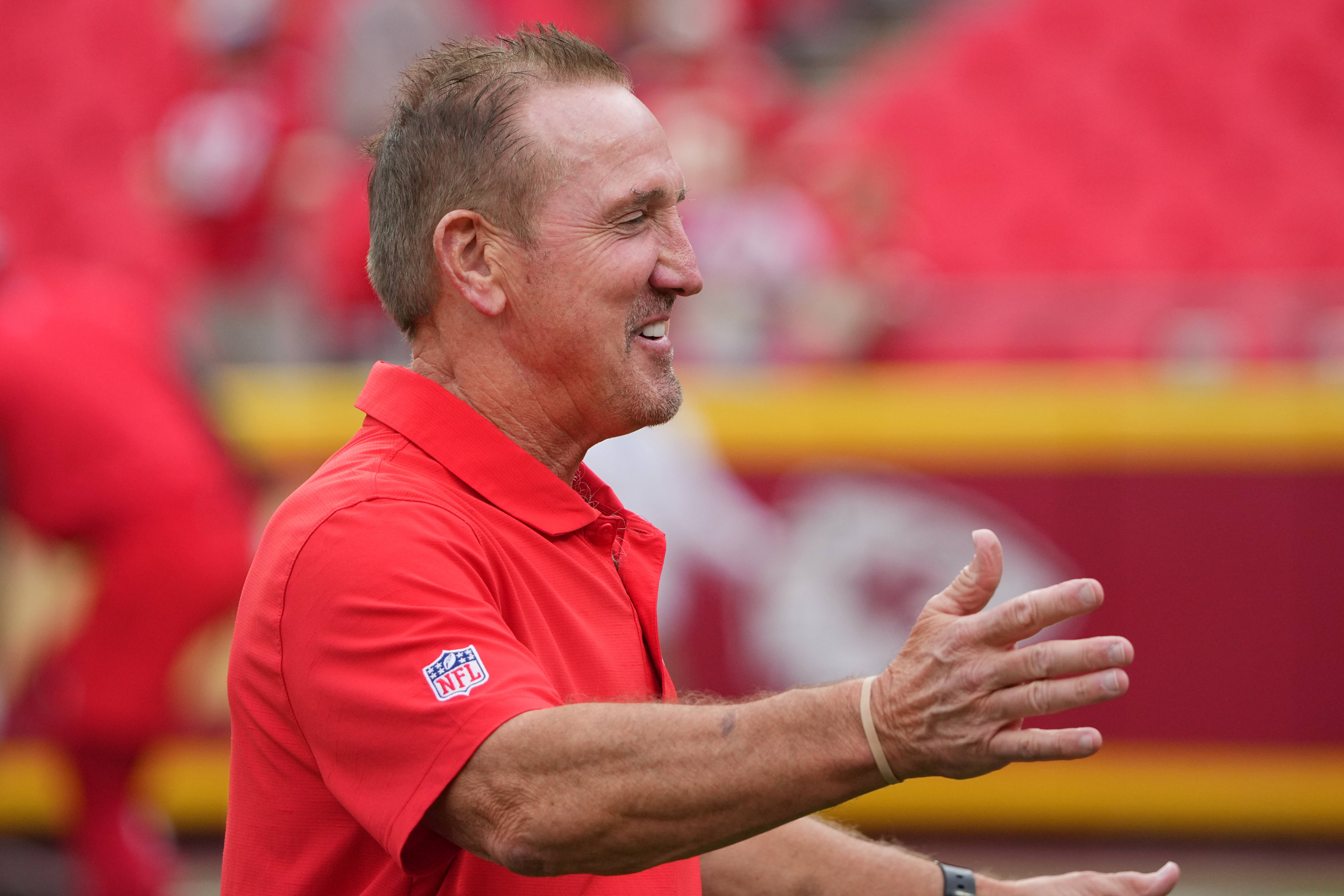 Aug 22, 2024; Kansas City, Missouri, USA; Kansas City Chiefs defensive coordinator Steve Spagnuolo greets a friend on field during warm ups against the Chicago Bears prior to a game at GEHA Field at Arrowhead Stadium.