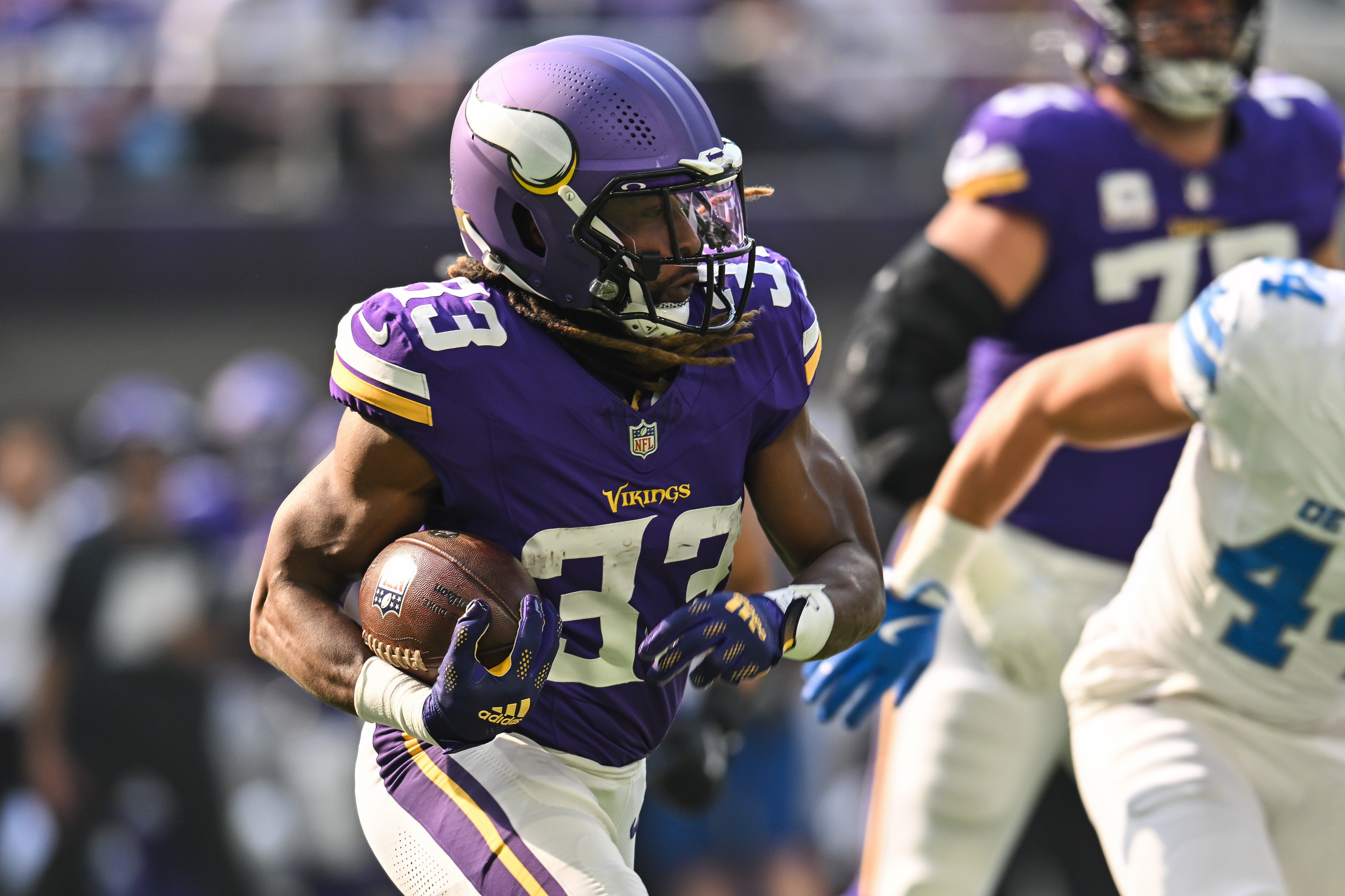 Oct 20, 2024; Minneapolis, Minnesota, USA; Minnesota Vikings running back Aaron Jones (33) runs the ball against the Detroit Lions during the first quarter at U.S. Bank Stadium.