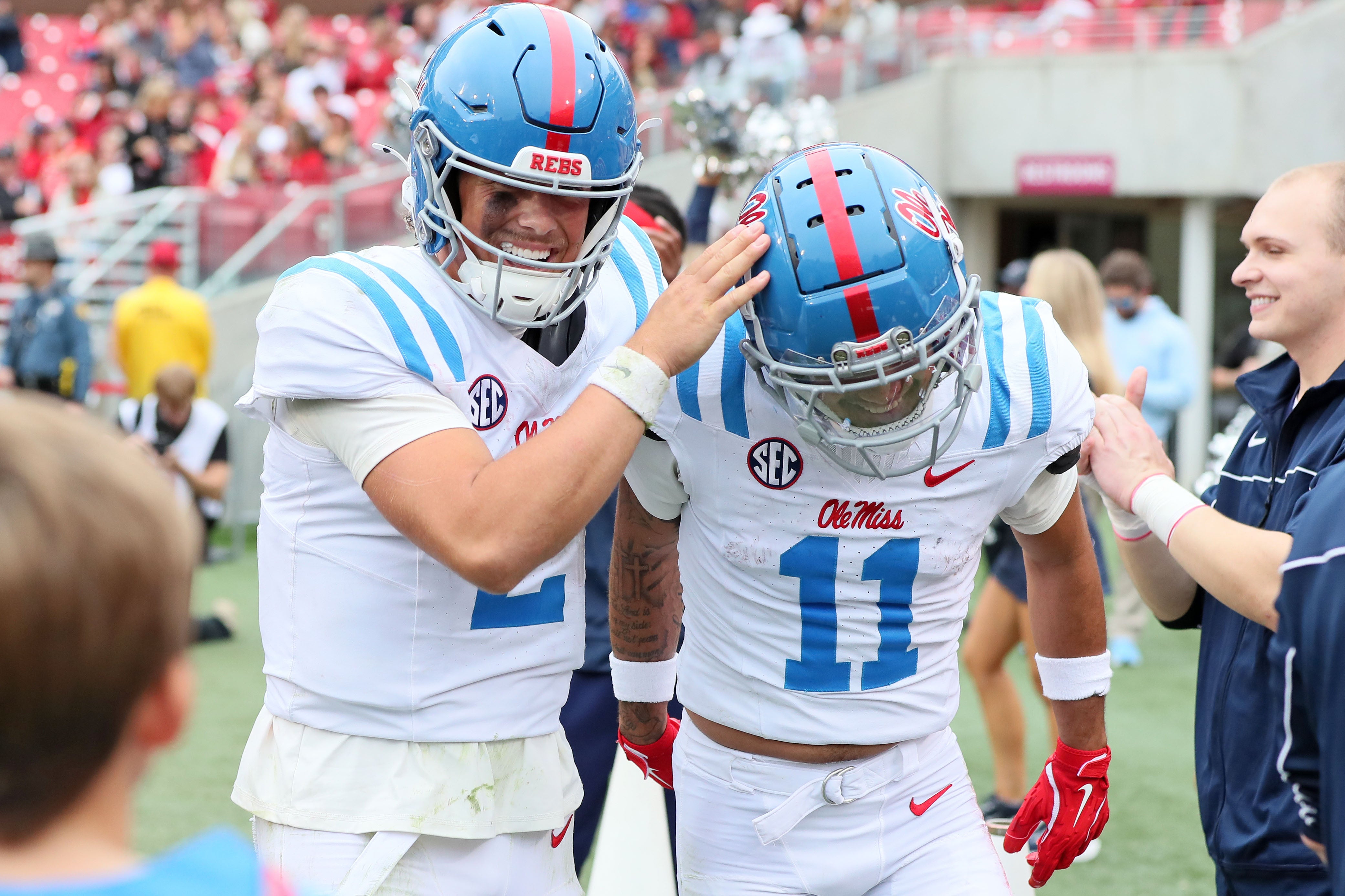 Nov 2, 2024; Fayetteville, Arkansas, USA; Ole Miss Rebels quarterback Jaxson Dart (2) and wide receiver Jordan Watkins (11) celebrate after a touchdown in the third quarter against the Arkansas Razorbacks at Donald W. Reynolds Razorback Stadium. Mississippi won 63-31.