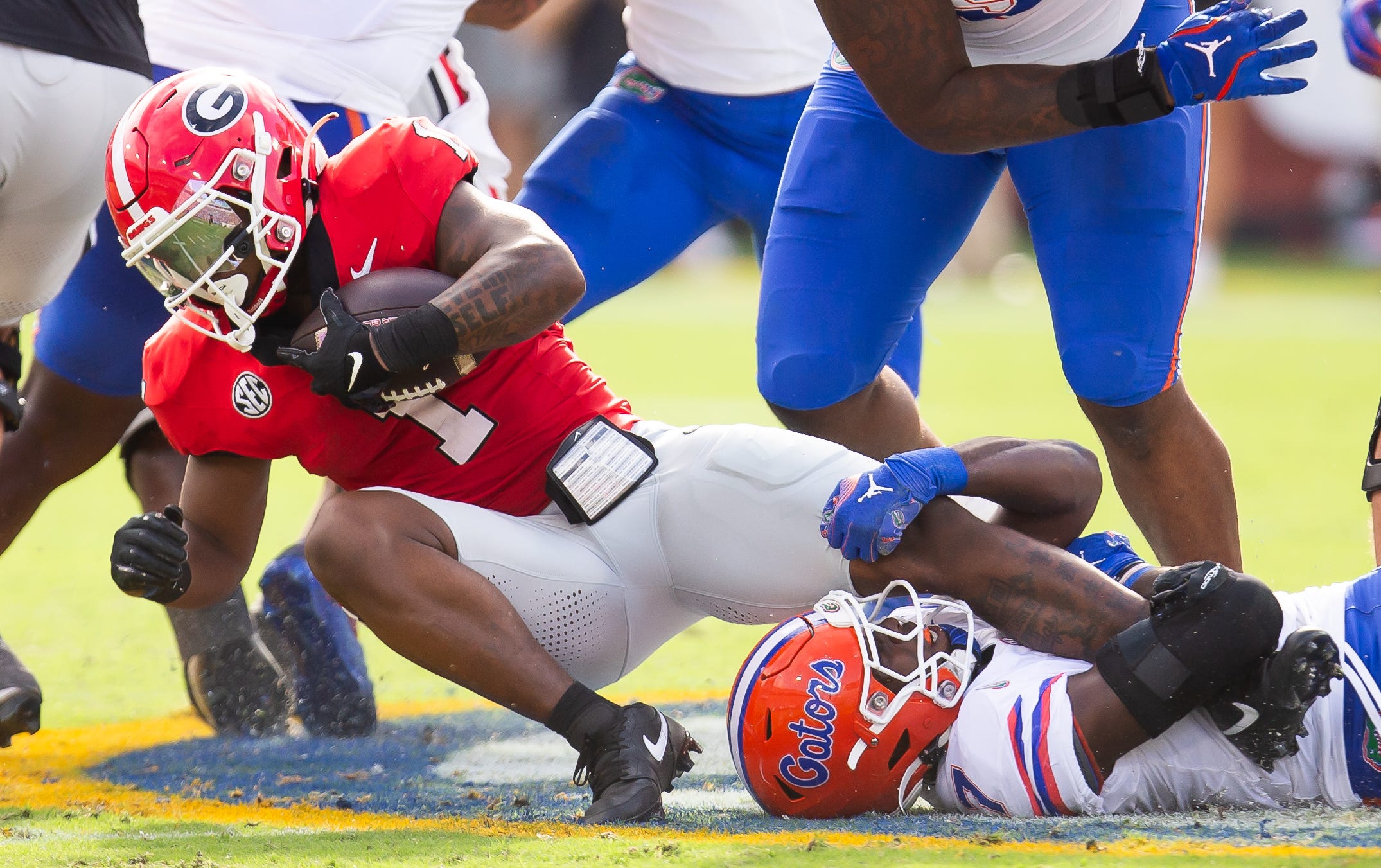 Florida Gators defensive back Trikweze Bridges (7) tacks Georgia Bulldogs running back Trevor Etienne (1) during the first half at EverBank Stadium in Jacksonville, FL on Saturday, November 2, 2024.
