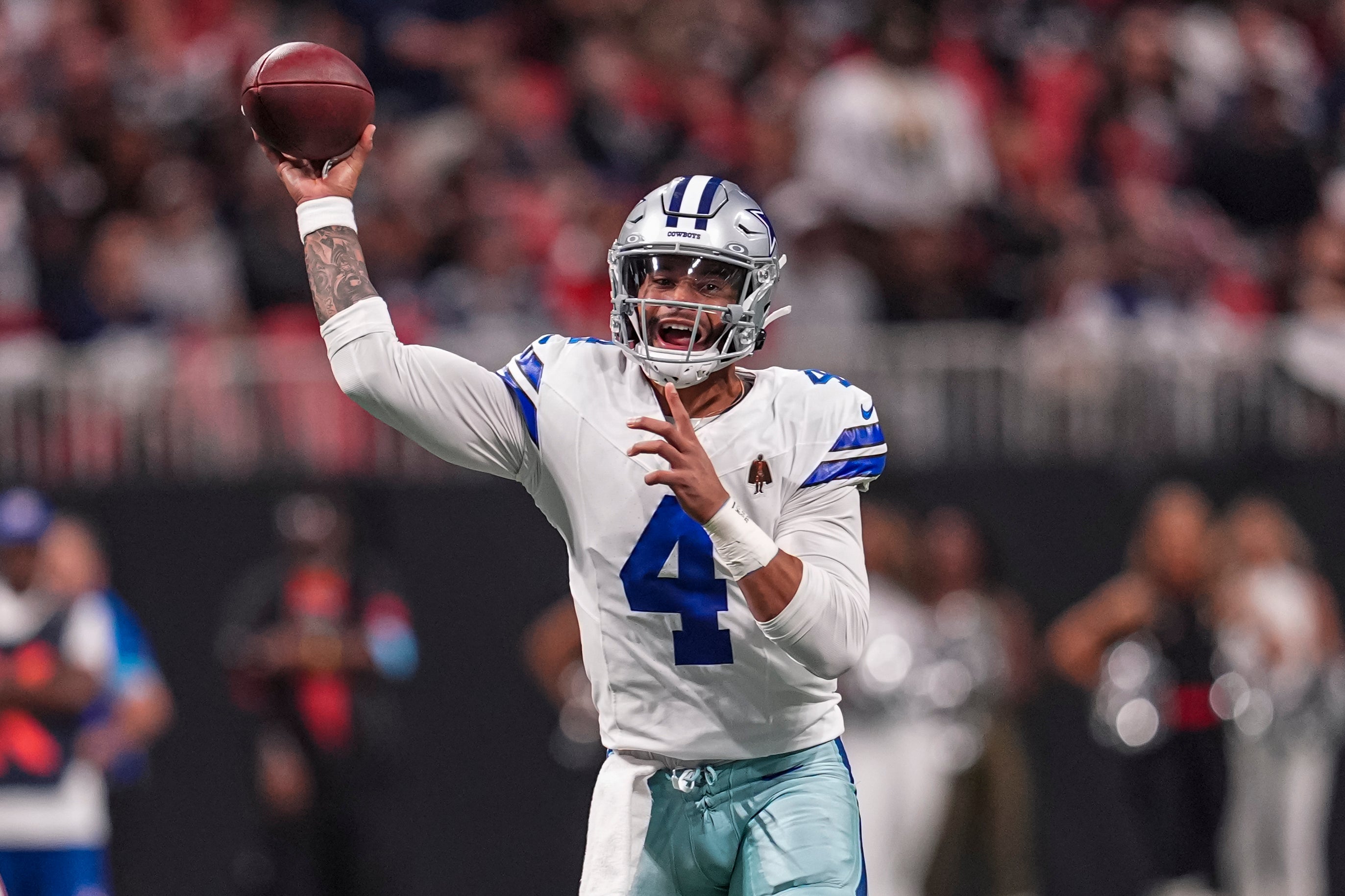 Dallas Cowboys quarterback Dak Prescott (4) passes against the Atlanta Falcons during the first quarter at Mercedes-Benz Stadium.