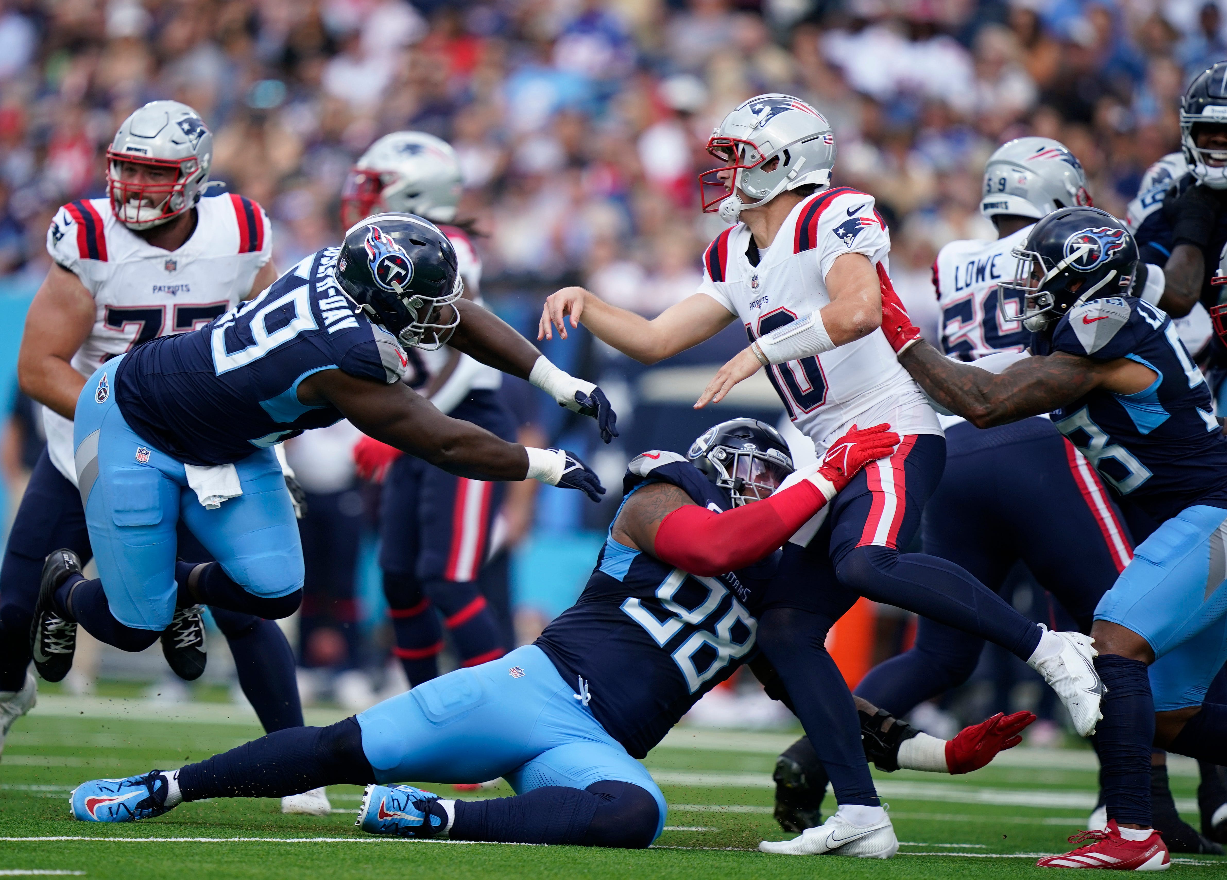 Tennessee Titans defensive tackles Jeffery Simmons (98) and Sebastian Joseph-Day (69) almost get to New England Patriots quarterback Drake Maye (10) at Nissan Stadium in Nashville, Tenn., Sunday, Nov. 3, 2024.