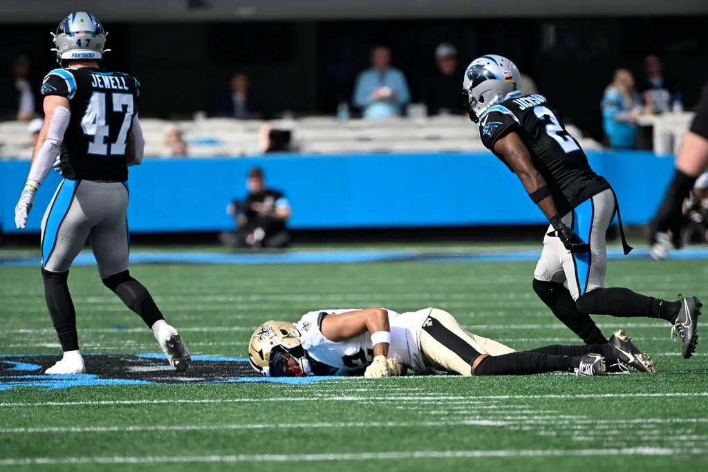 New Orleans Saints wide receiver Chris Olave (12) on the ground after a missed pass attempt as Carolina Panthers linebacker Josey Jewell (47) and cornerback Michael Jackson (2)