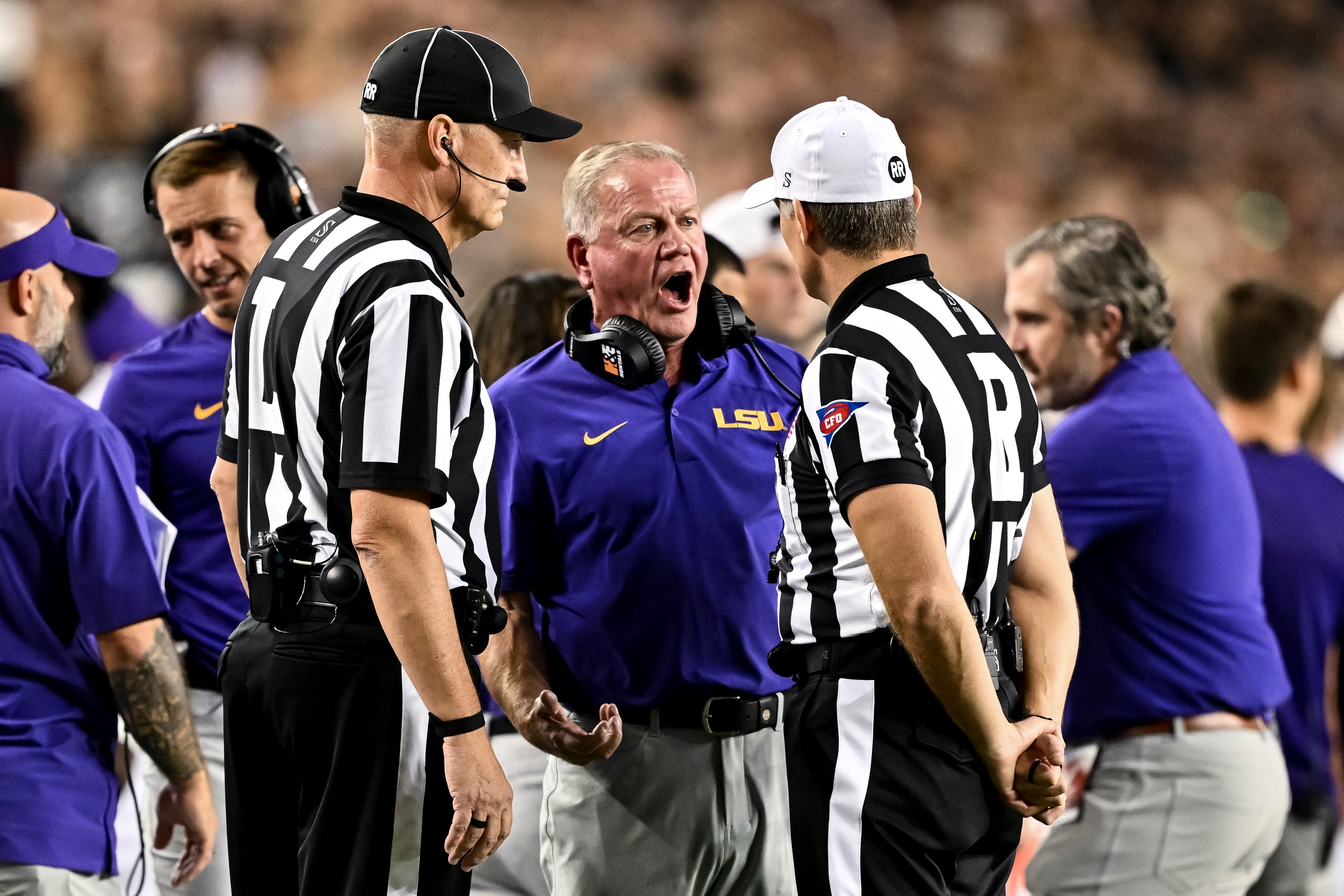 LSU Tigers head coach Brian Kelly speaks with the officials during a time out in the second quarter against the LSU Tigers at Kyle Field.