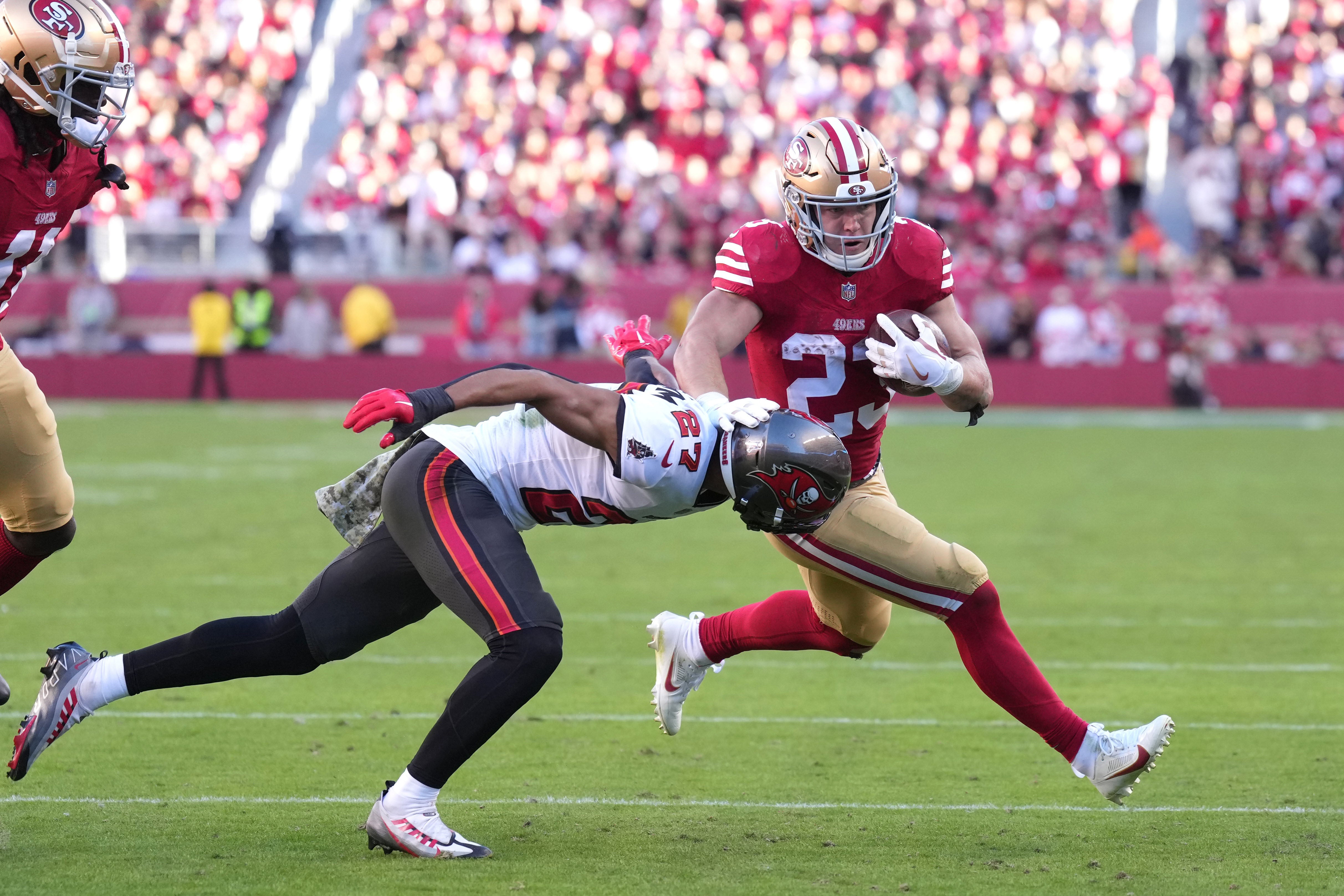 San Francisco 49ers running back Christian McCaffrey (23) carries the ball against Tampa Bay Buccaneers cornerback Zyon McCollum (27) during the third quarter at Levi's Stadium.