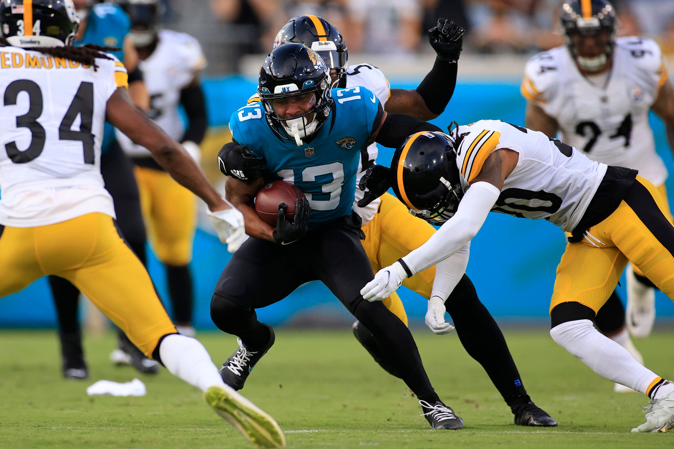 Jacksonville Jaguars wide receiver Christian Kirk #13 is tackled by Pittsburgh Steelers cornerback Cameron Sutton #20 during the first quarter of an NFL preseason game Saturday, Aug. 20, 2022 at TIAA Bank Field in Jacksonville. [