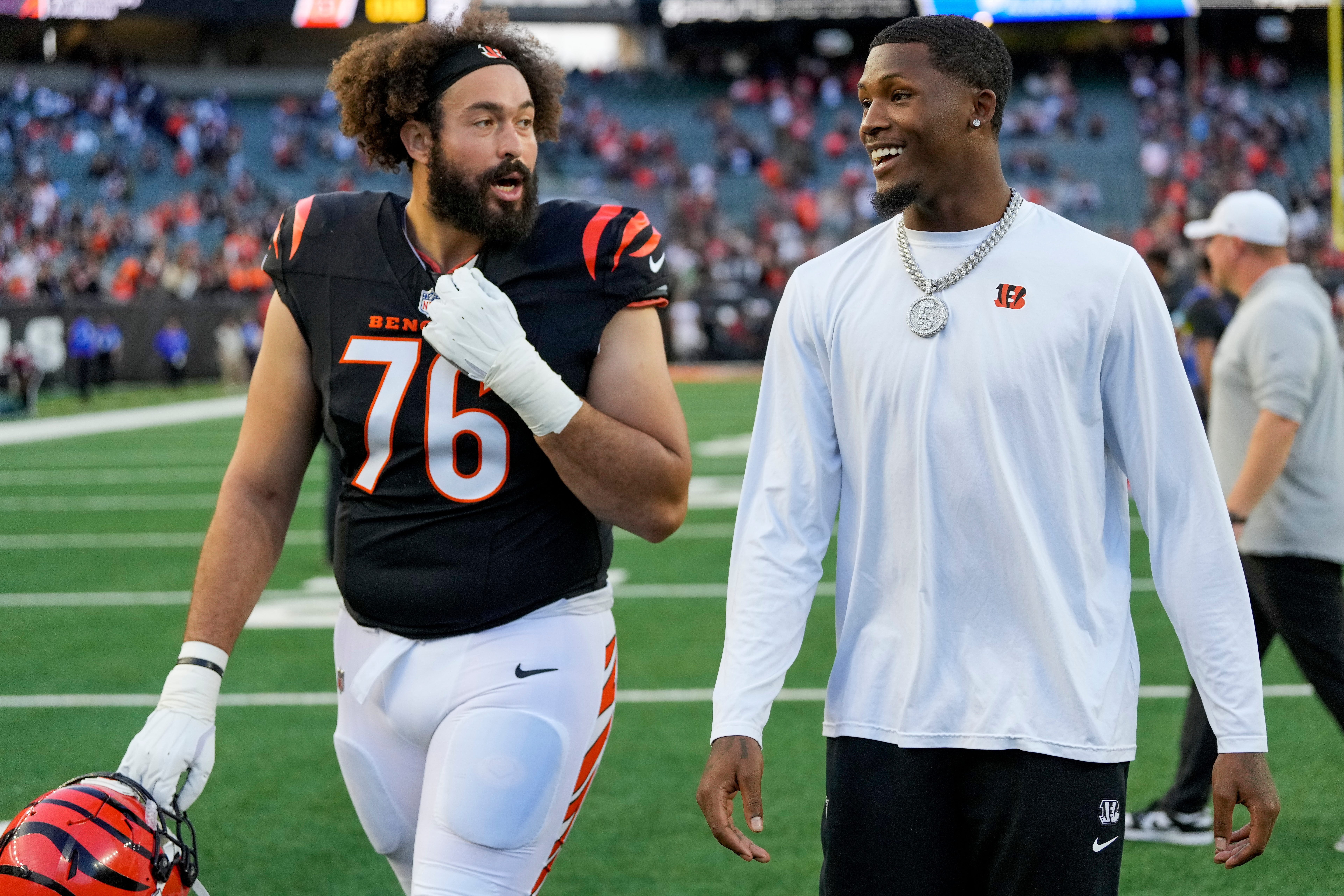 Injured Cincinnati Bengals wide receiver Tee Higgins (5) heads for the locker room with offensive tackle Devin Cochran (76) after the fourth quarter of the NFL Week 9 game between the Cincinnati Bengals and the Las Vegas Raiders at Paycor Stadium in downtown Cincinnati on Sunday, Nov. 3, 2024. The Bengals collected their first win at home with a 41-24 victory over the Raiders.