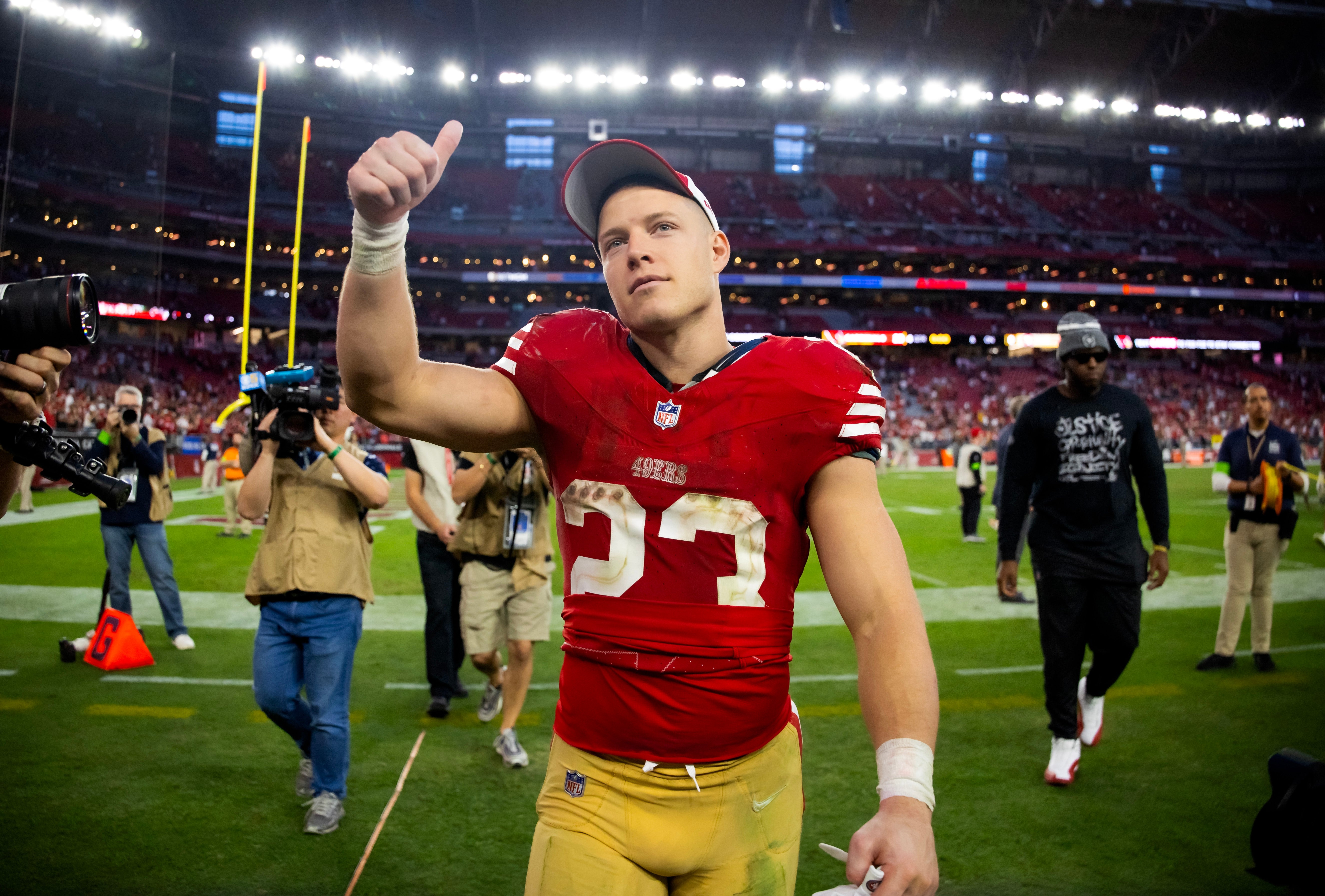 San Francisco 49ers running back Christian McCaffrey (23) celebrates after beating the Arizona Cardinals at State Farm Stadium.