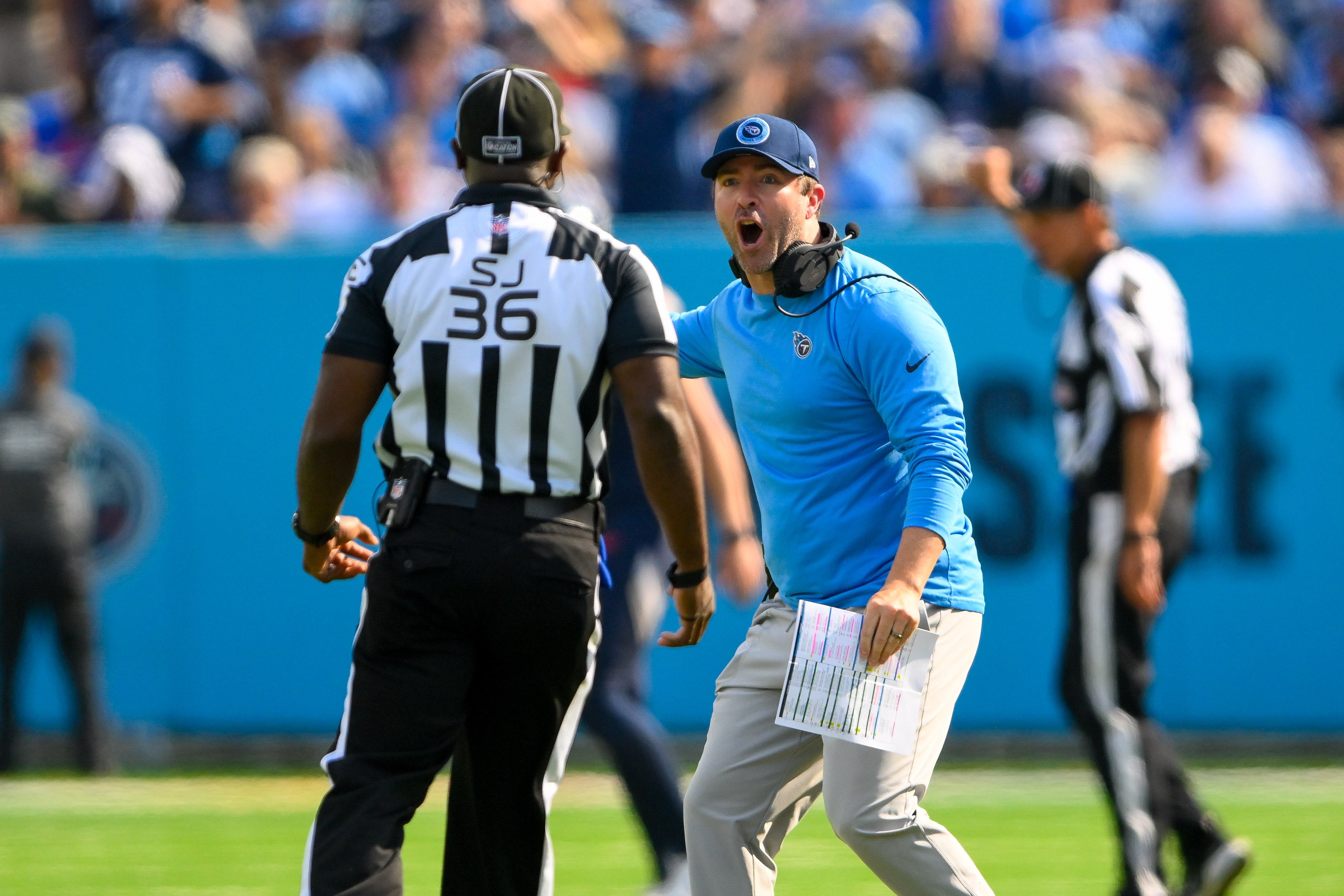 Oct 13, 2024; Nashville, Tennessee, USA; Tennessee Titans head coach Brian Callahan yes to field judge Anthony Jeffries (36) after a no calls was made on a pass interference during the second half at Nissan Stadium. Mandatory Credit: Steve Roberts-Imagn Images