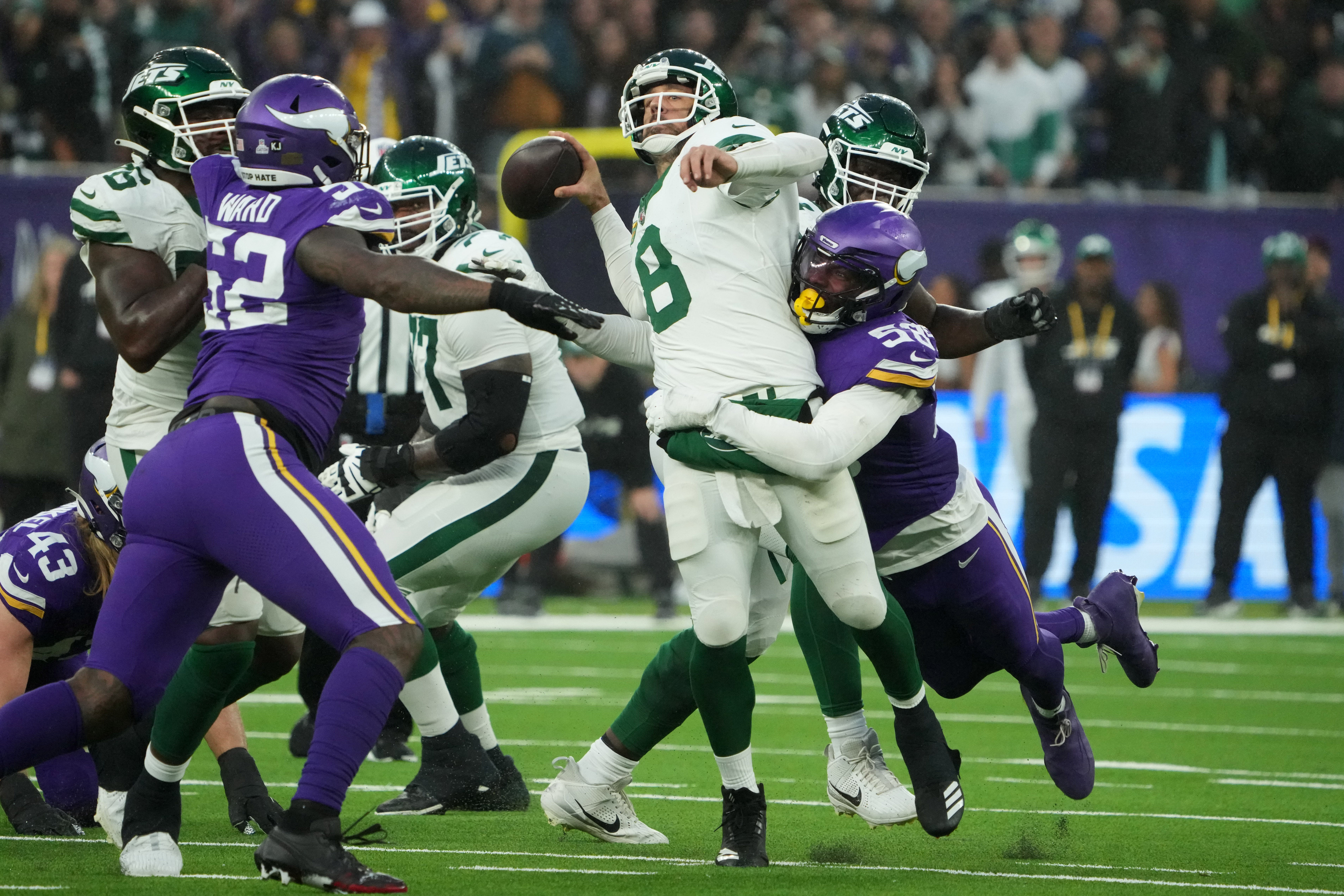 Oct 6, 2024; London, United Kingdom; New York Jets quarterback Aaron Rodgers (8) throws the ball under pressure from Minnesota Vikings linebacker Jonathan Greenard (58) in the fourth quarter at Tottenham Hotspur Stadium.