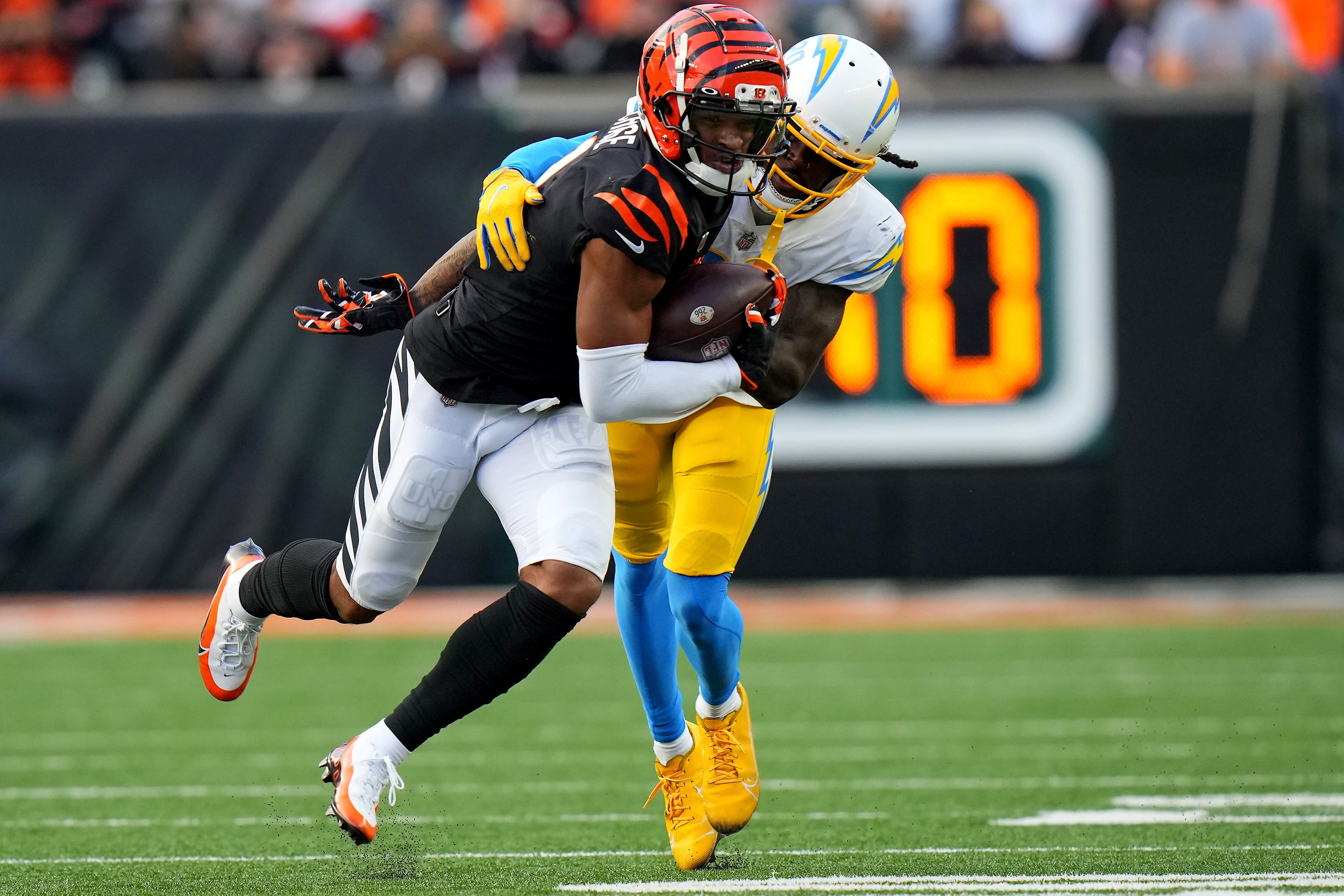 Cincinnati Bengals wide receiver Ja'Marr Chase (1) turns downfield after completing a catch as Los Angeles Chargers defensive back Tevaughn Campbell (20) defends in the fourth quarter during a Week 13 NFL football game, Sunday, Dec. 5, 2021, at Paul Brown Stadium in Cincinnati. The Los Angeles Chargers defeated the Cincinnati Bengals, 41-22. Los Angeles Chargers At Cincinnati Bengals Dec 5  