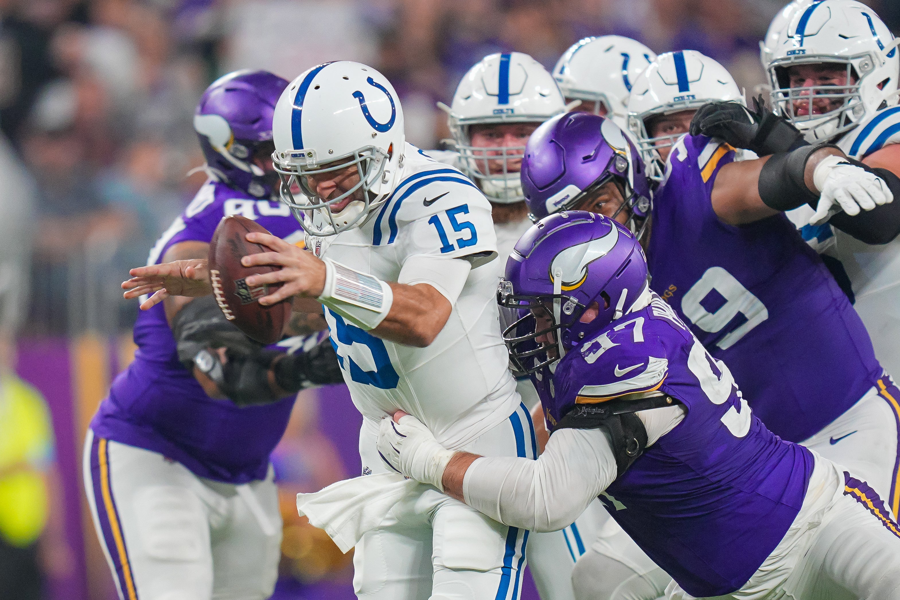 Nov 3, 2024; Minneapolis, Minnesota, USA; Minnesota Vikings defensive tackle Harrison Phillips (97) tackles Indianapolis Colts quarterback Joe Flacco (15) in the fourth quarter at U.S. Bank Stadium.