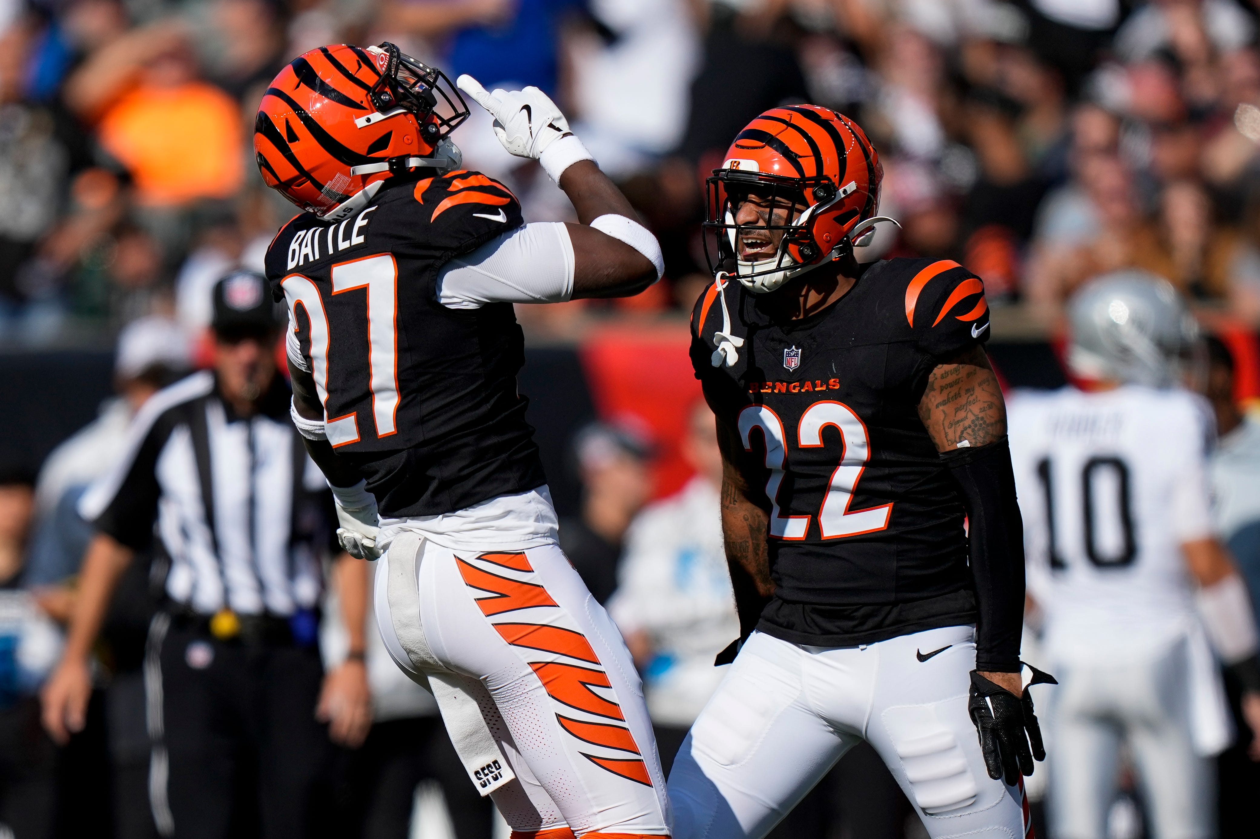 Cincinnati Bengals safety Jordan Battle (27) and safety Geno Stone (22) celebrate a stop in the second quarter of the NFL Week 9 game between the Cincinnati Bengals and the Las Vegas Raiders at Paycor Stadium in downtown Cincinnati on Sunday, Nov. 3, 2024.