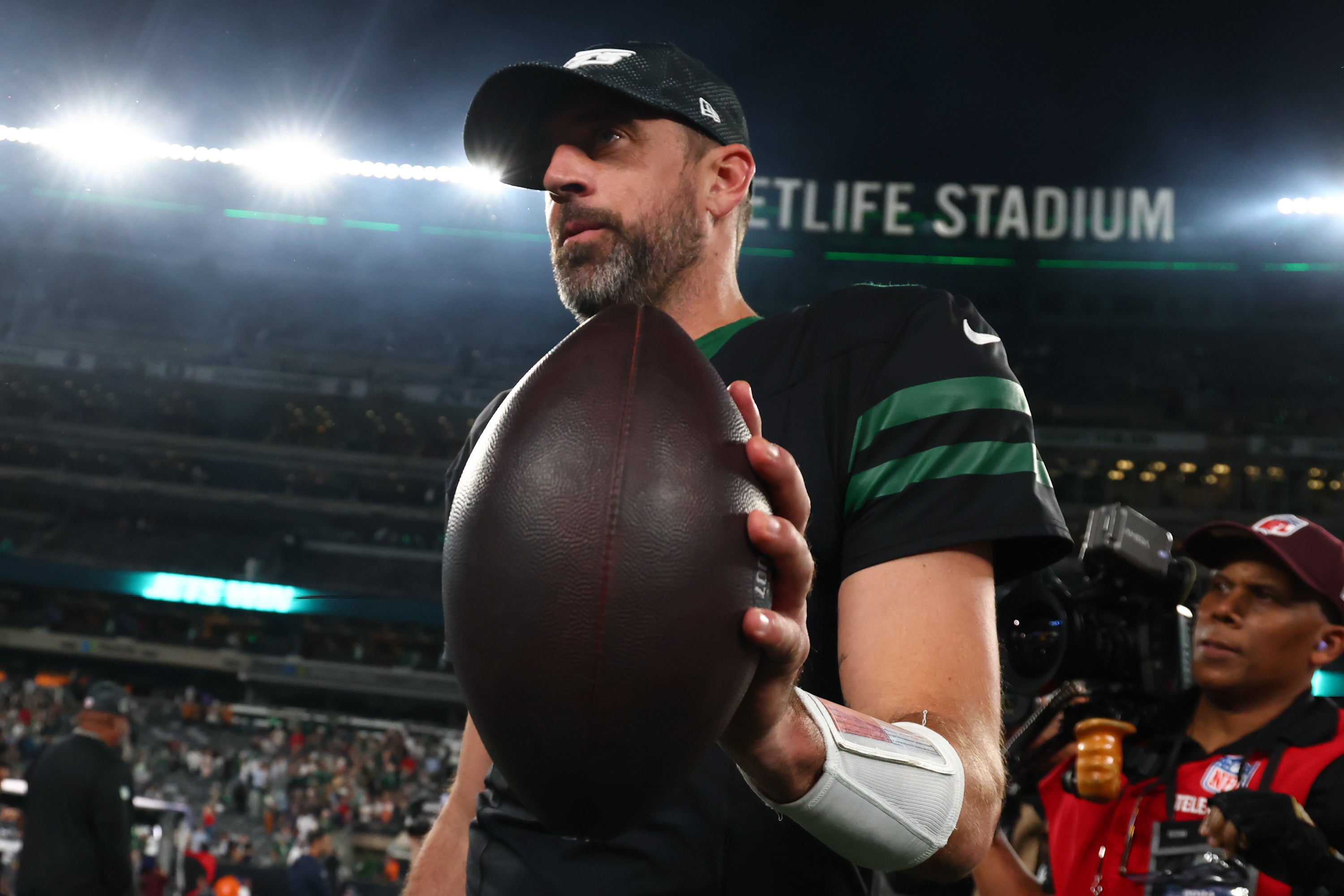 New York Jets quarterback Aaron Rodgers (8) walks off the field after the Jets win over the Houston Texans at MetLife Stadium.