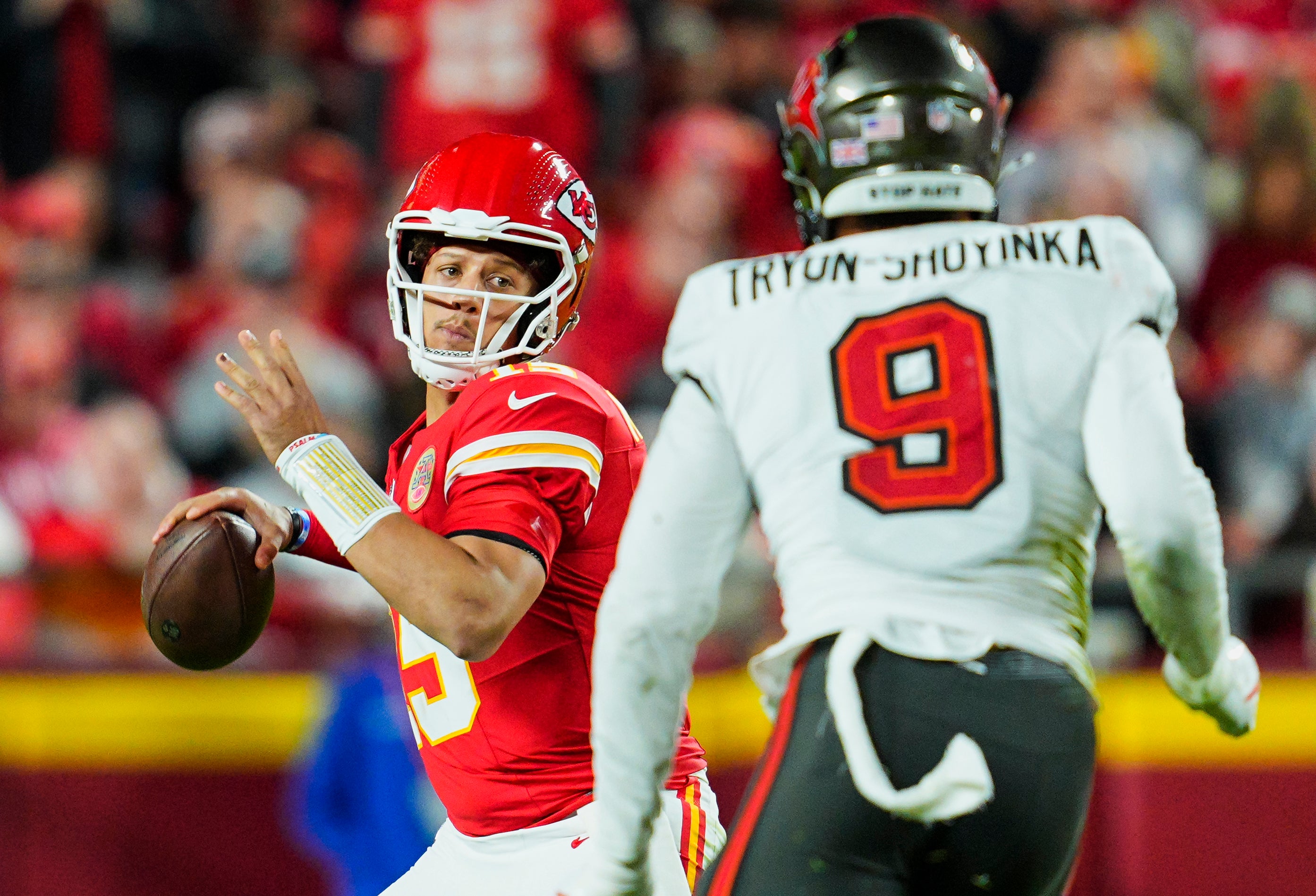 Nov 4, 2024; Kansas City, Missouri, USA; Kansas City Chiefs quarterback Patrick Mahomes (15) throws a pass against Tampa Bay Buccaneers linebacker Joe Tryon-Shoyinka (9) at GEHA Field at Arrowhead Stadium.
