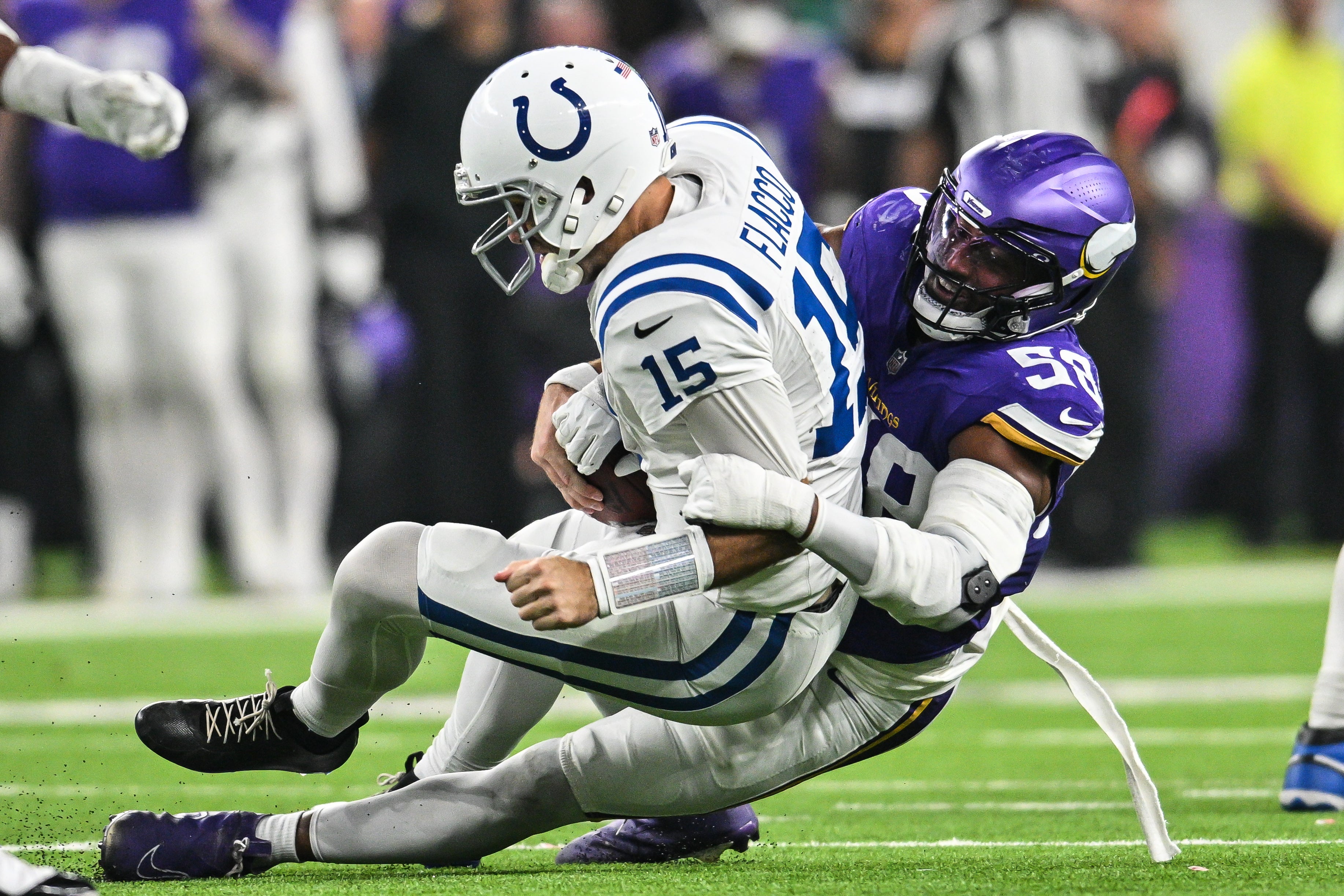 Nov 3, 2024; Minneapolis, Minnesota, USA; Minnesota Vikings linebacker Jonathan Greenard (58) sacks Indianapolis Colts quarterback Joe Flacco (15) during the fourth quarter at U.S. Bank Stadium.