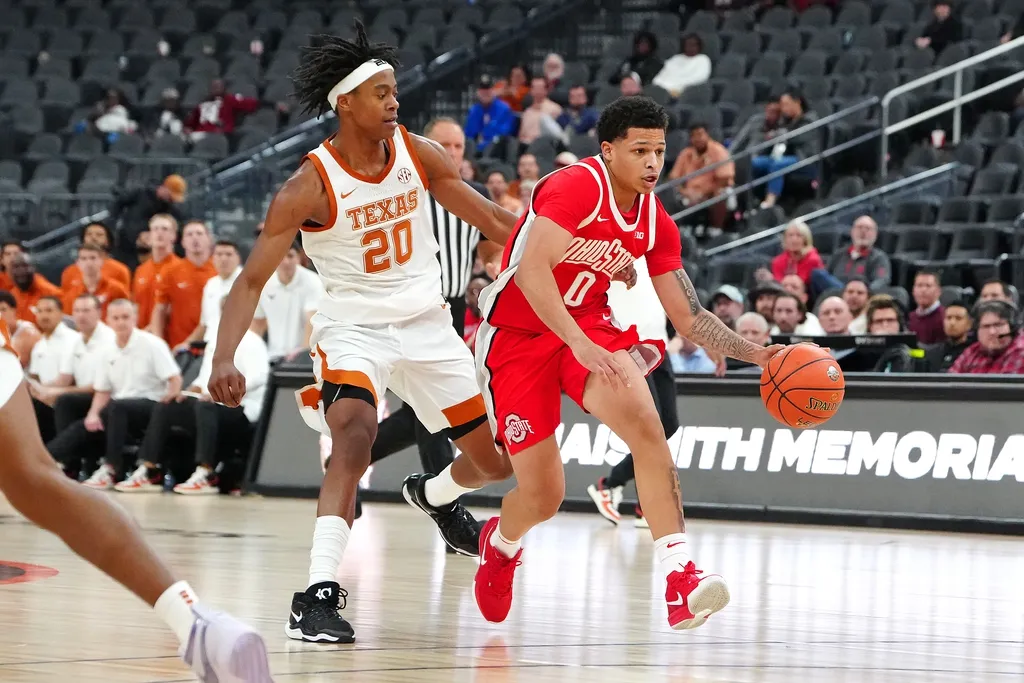 Ohio State Buckeyes guard John Mobley Jr. (0) dribbles ahead of Texas Longhorns guard Tre Johnson (20) during the second half at T-Mobile Arena.
