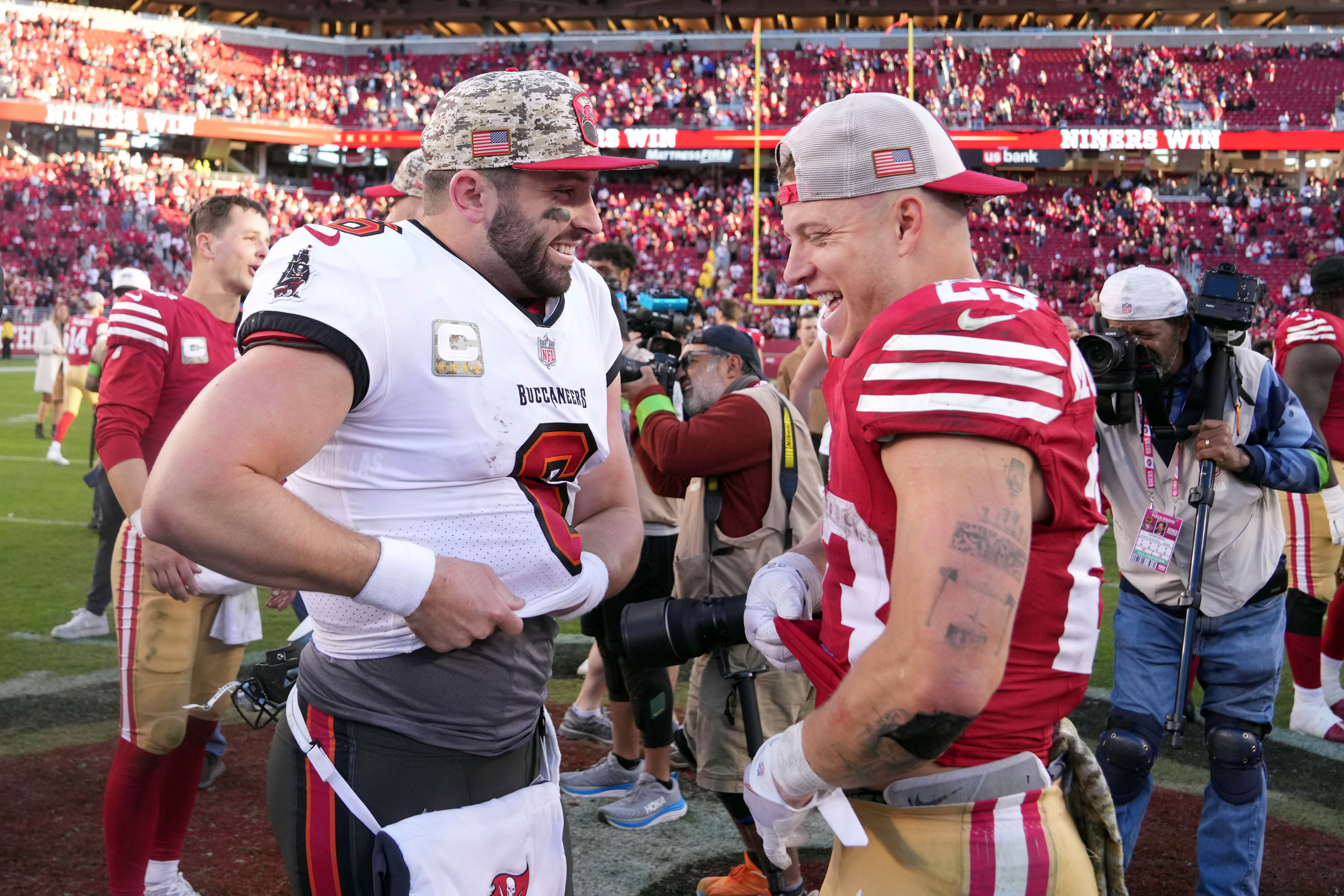 Tampa Bay Buccaneers quarterback Baker Mayfield (left) and San Francisco 49ers running back Christian McCaffrey (right) talk after the game at Levi's Stadium.