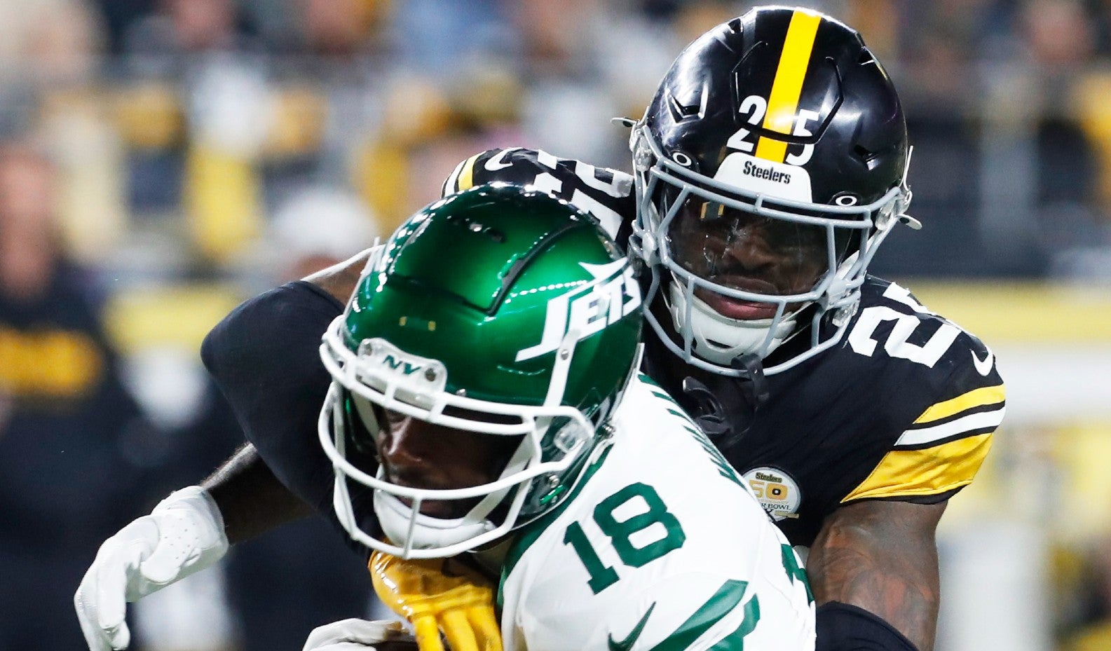 Oct 20, 2024; Pittsburgh, Pennsylvania, USA; Pittsburgh Steelers safety DeShon Elliott (25) tackles New York Jets wide receiver Mike Williams (18) after a catch during the third quarter against at Acrisure Stadium.