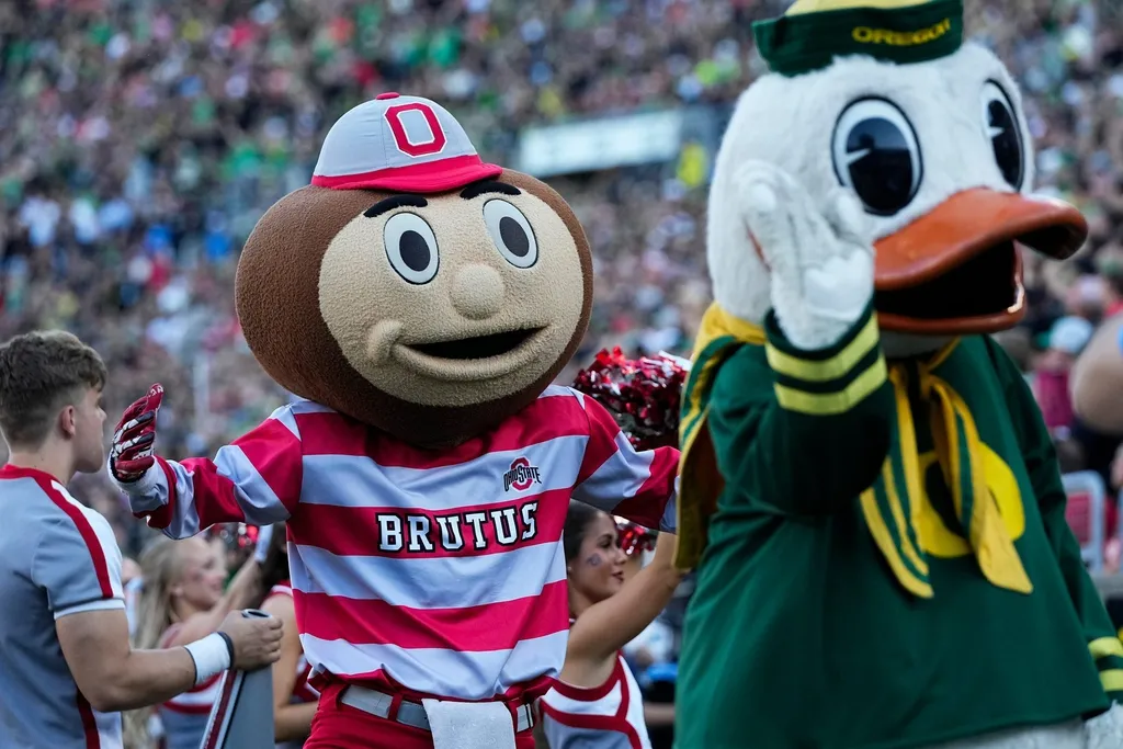 Ohio State Buckeyes mascot Brutus and the Oregon Duck interact during the first half of the NCAA football game at Autzen Stadium.
