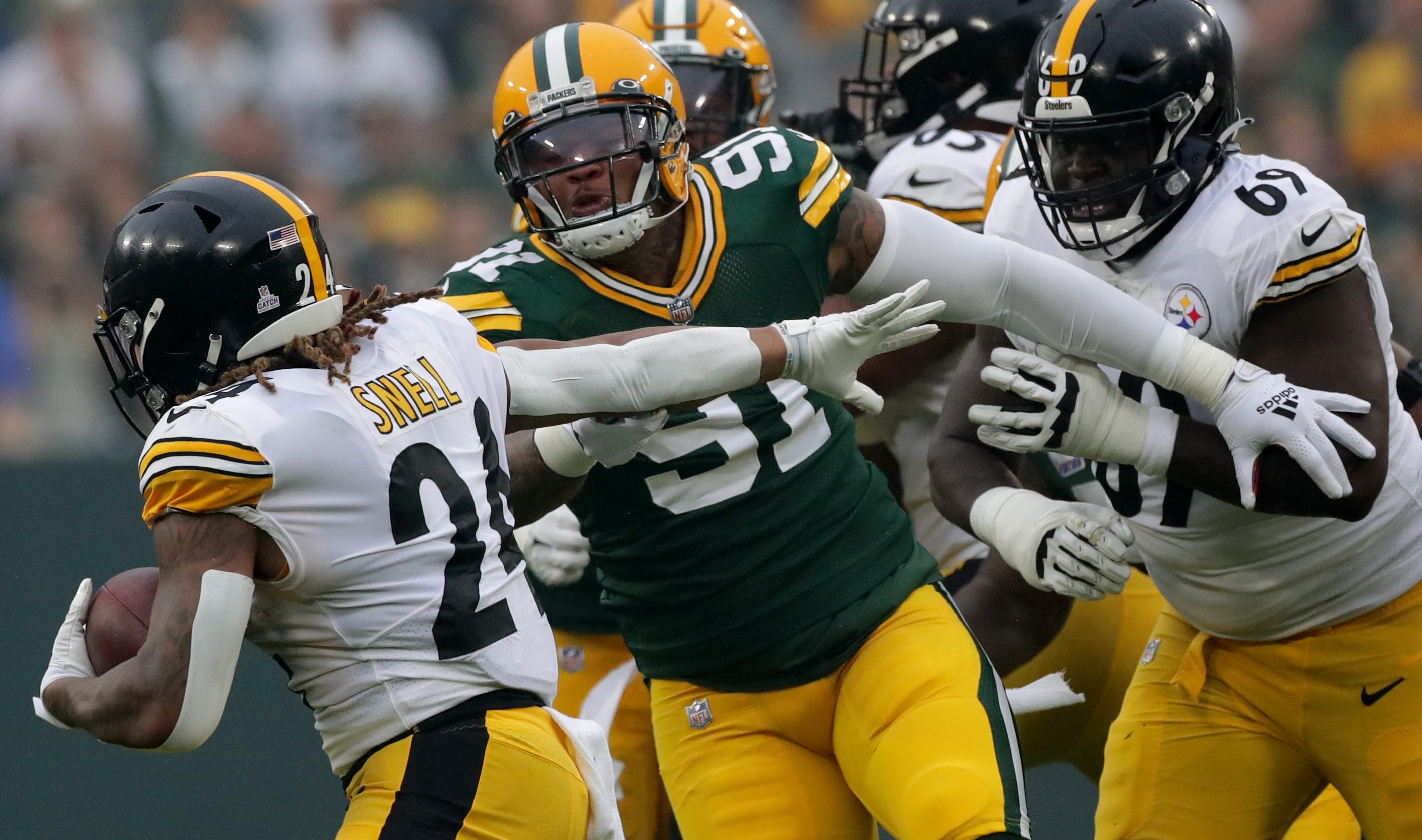 Green Bay Packers outside linebacker Preston Smith (91) tackles Pittsburgh Steelers running back Benny Snell (24) during the first quarter of their game Sunday, October 3, 2021 at Lambeau Field in Green Bay, Wis. Green Bay Packers beat the Pittsburgh Steelers 27-17. Packers04 25