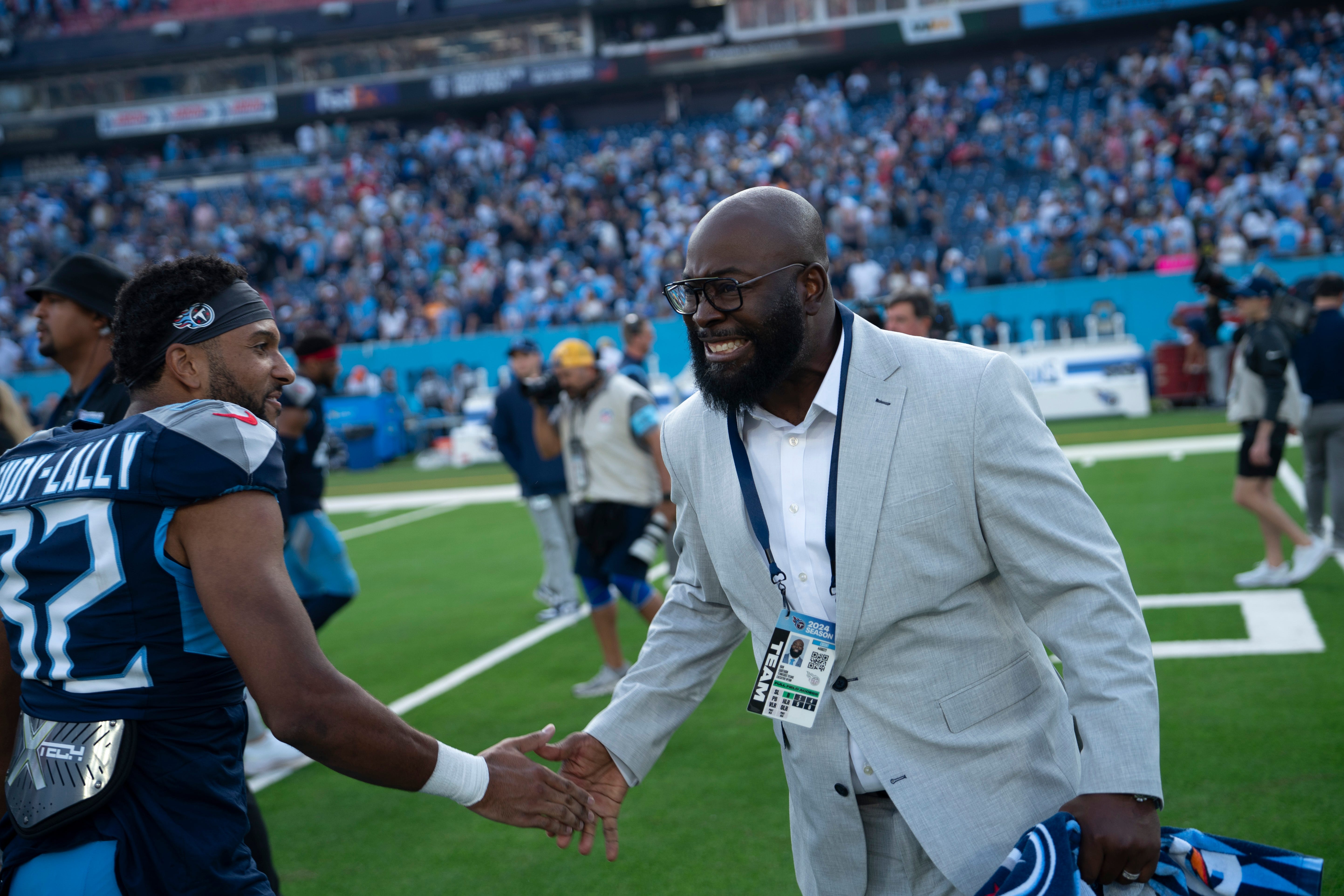 Tennessee Titans General Manager Ran Carthon celebrates with Tennessee Titans cornerback Gabe Jeudy-Lally (32) after his team's overtime 20-17 win against the New England Patriots at Nissan Stadium in Nashville, Tenn., Sunday, Nov. 3, 2024.
