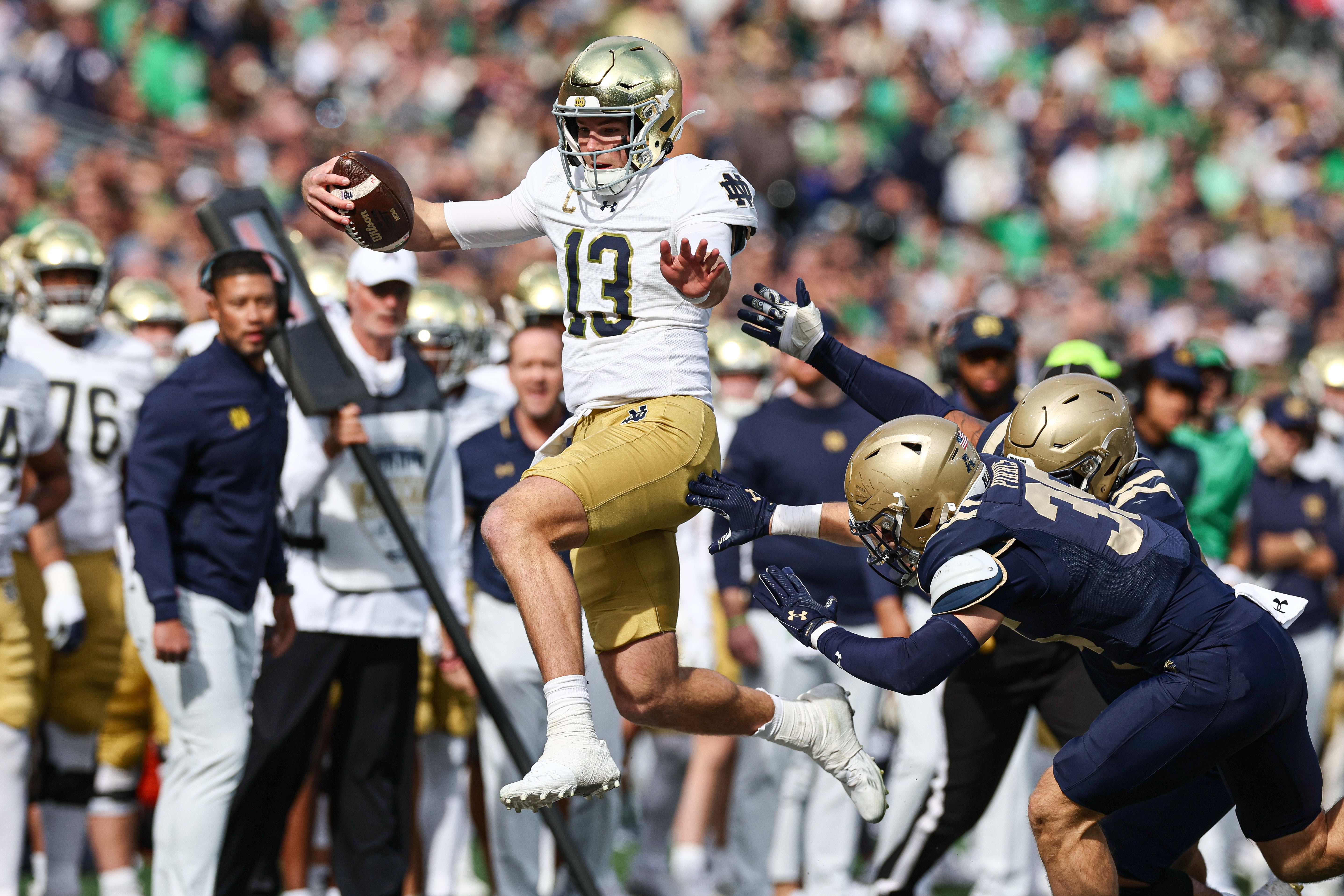 Notre Dame Fighting Irish quarterback Riley Leonard (13) carries the ball during the first half against the Navy Midshipmen at MetLife Stadium.