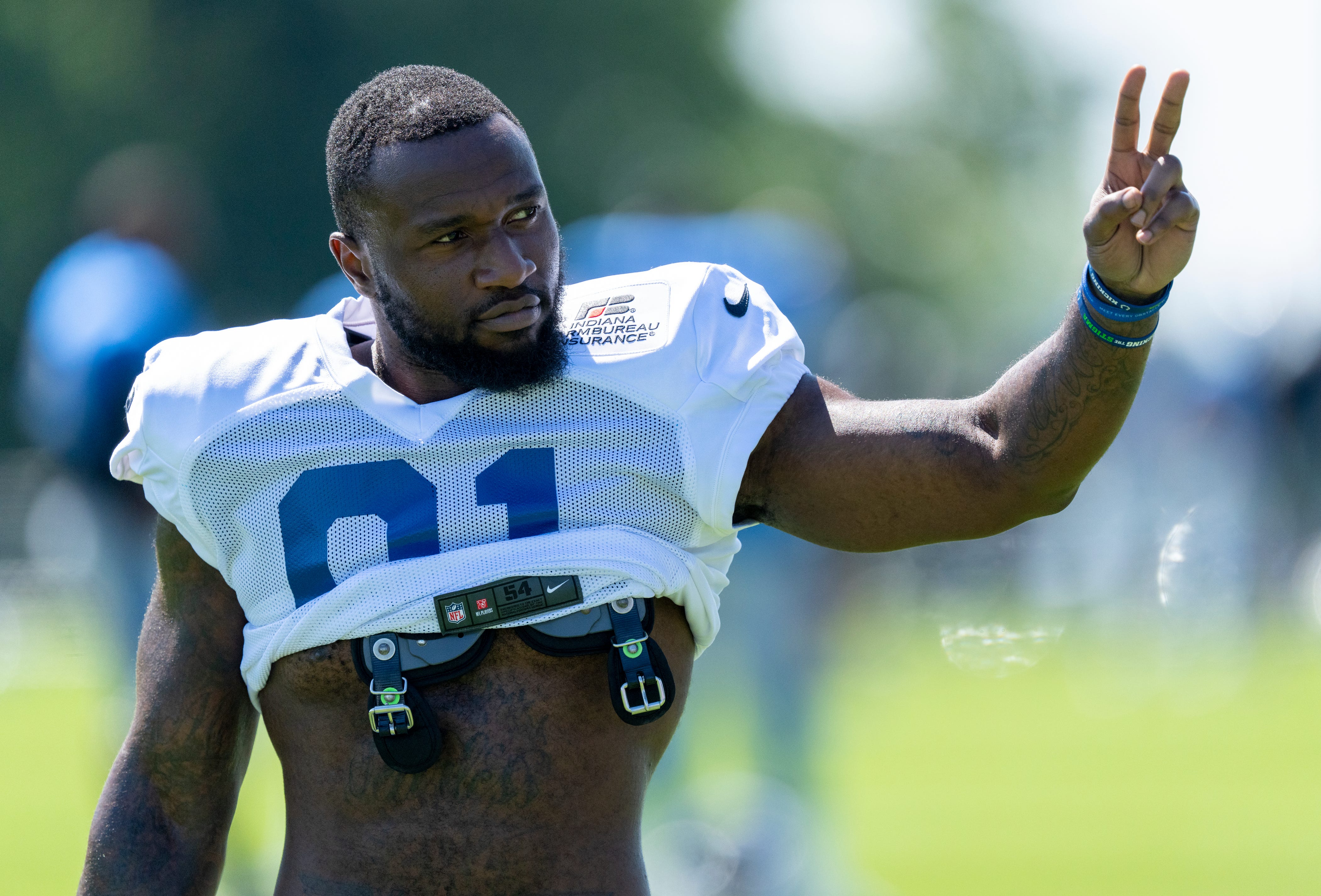 Indianapolis Colts defensive end Yannick Ngakoue (91) signals to fans during training camp Wednesday, Aug. 17, 2022, at Grand Park in Westfield, Ind.