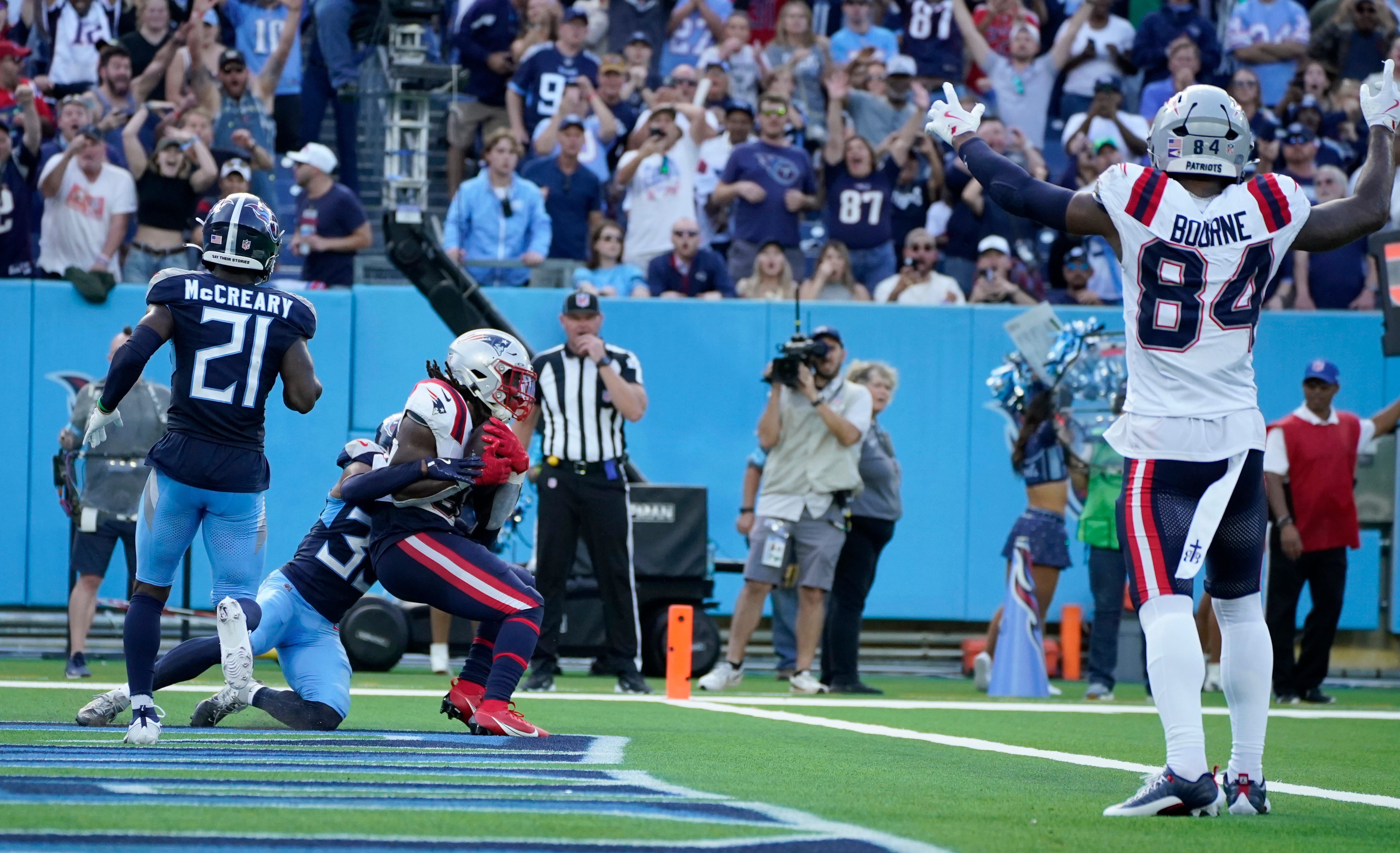 New England Patriots running back Rhamondre Stevenson (38) catches a touchdown pass over Tennessee Titans cornerback Darrell Baker Jr. (39) at the end of the 4th quarter to send the game into overtime at Nissan Stadium in Nashville, Tenn., Sunday, Nov. 3, 2024.