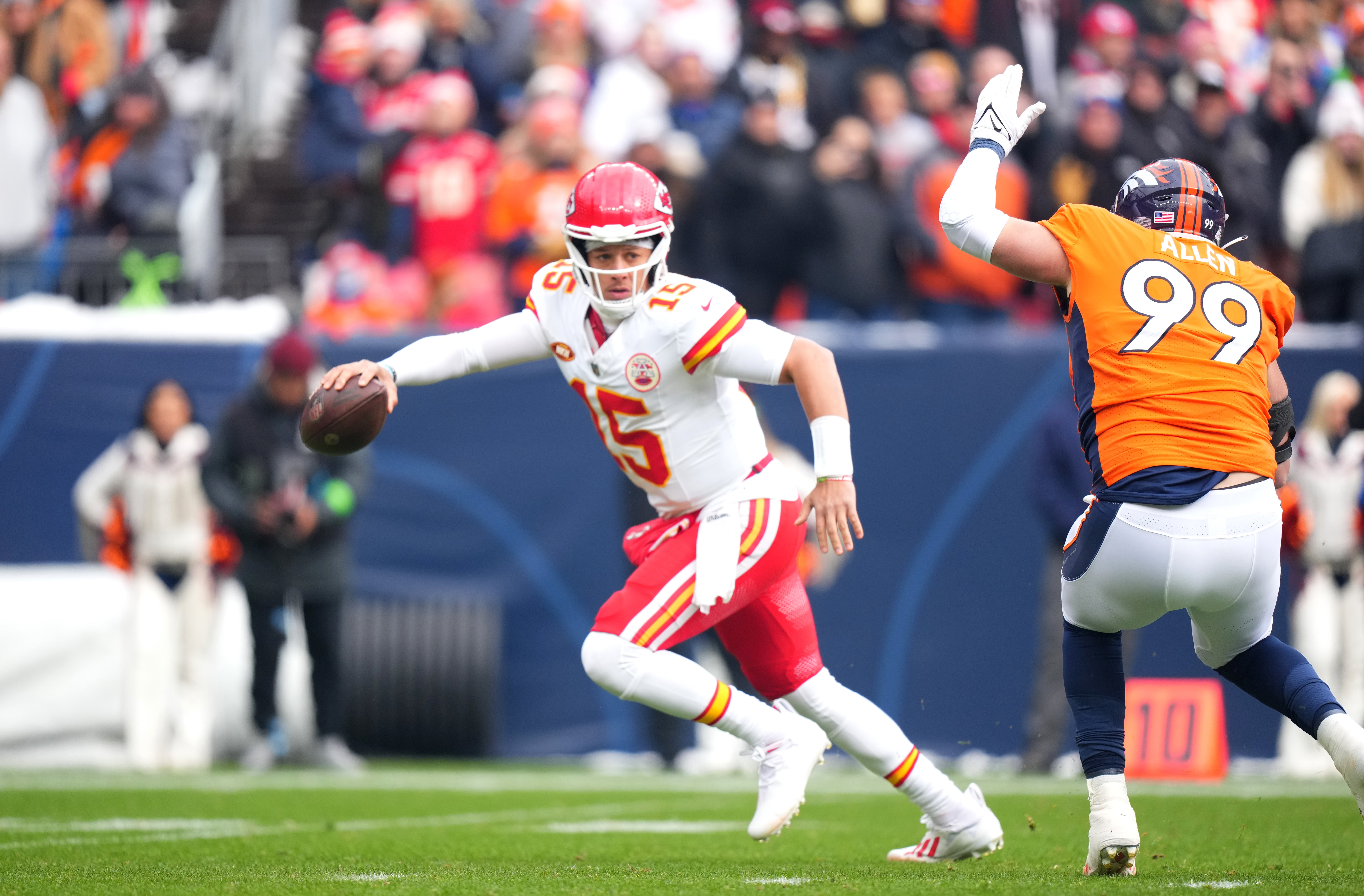 Chiefs quarterback Patrick Mahomes scrambles away from Denver Broncos defensive end Zach Allen.