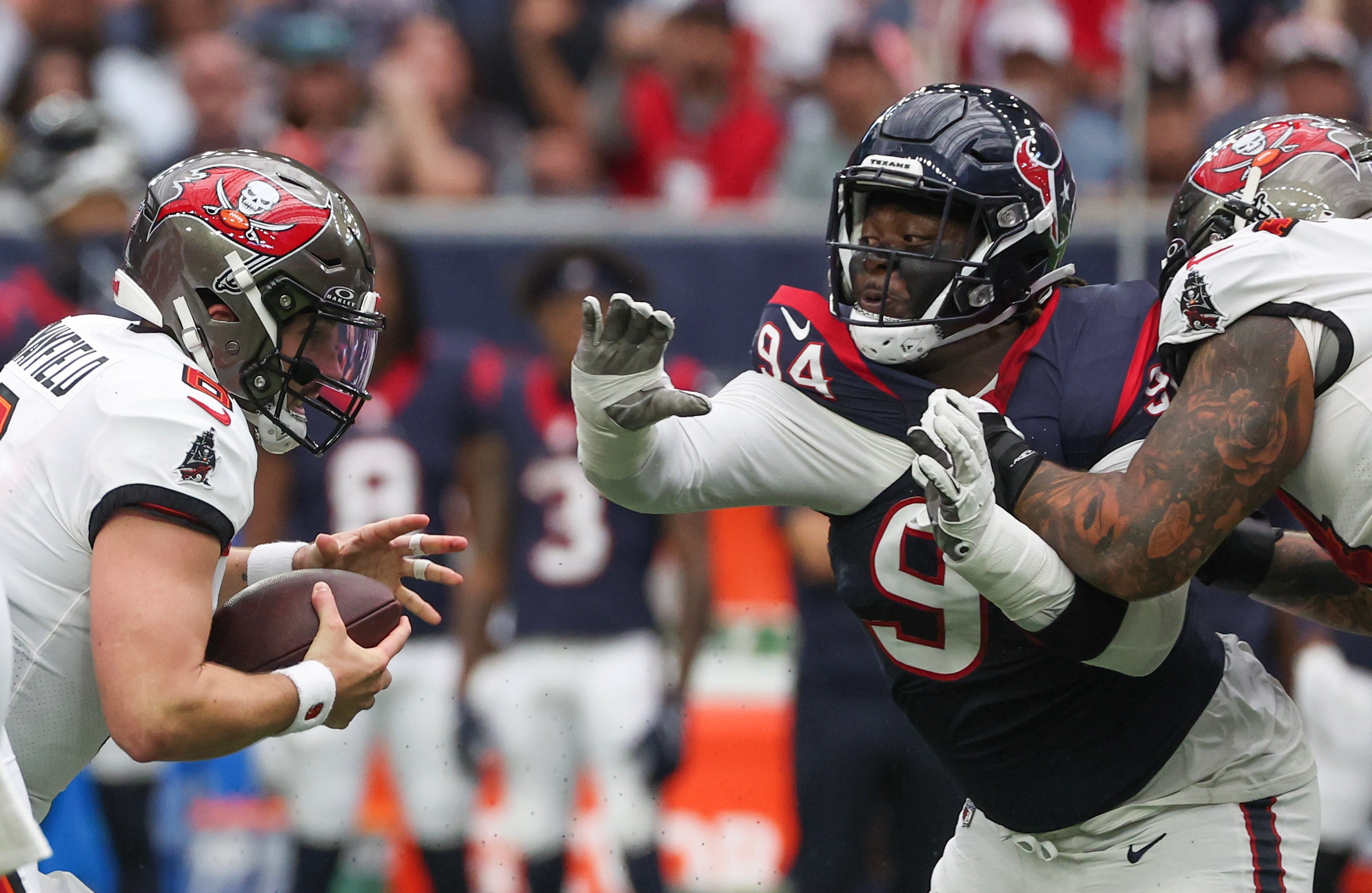 Tampa Bay Buccaneers quarterback Baker Mayfield (6) rushes against Houston Texans defensive tackle Khalil Davis (94) in the first quarter at NRG Stadium.