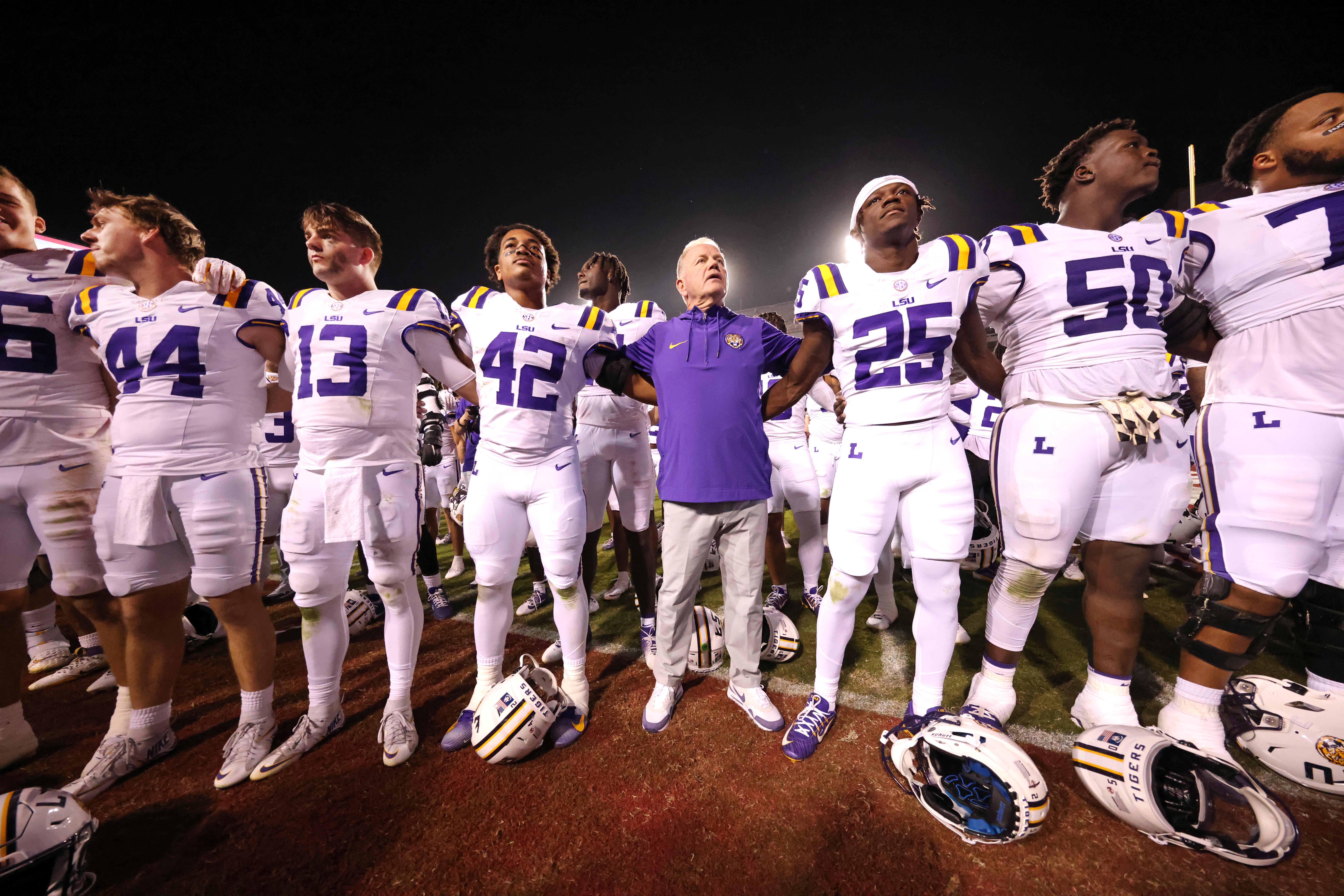 Oct 19, 2024; Fayetteville, Arkansas, USA; LSU Tigers quarterback Garrett Nussmeier (13) along with teammates and head coach Brian Kelly sing the LSU alma mater after a game against the Arkansas Razorbacks at Donald W. Reynolds Razorback Stadium. LSU won 34-10.