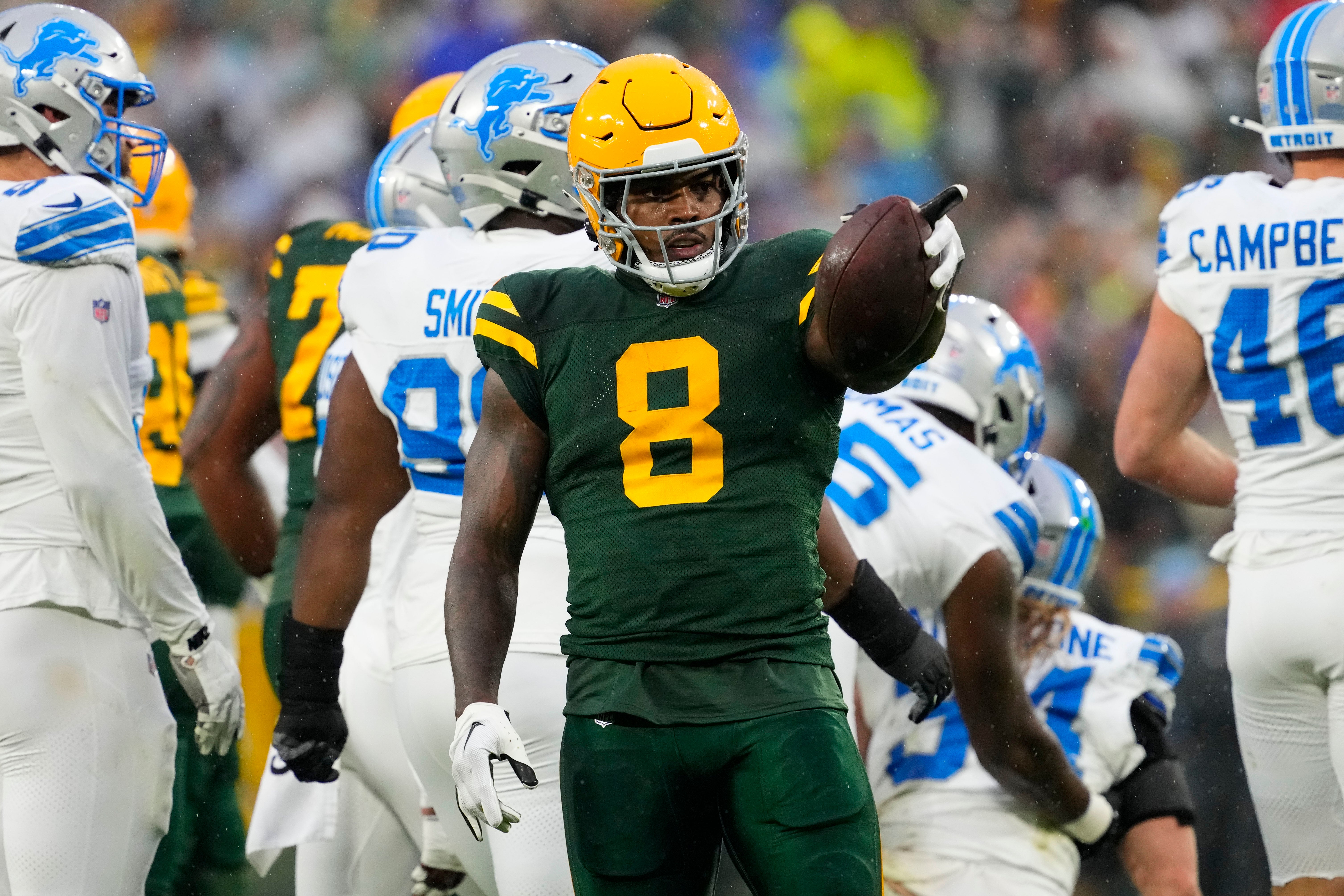 Green Bay Packers running back Josh Jacobs (8) gestures after earning a first down during the first quarter against the Detroit Lions at Lambeau Field. 