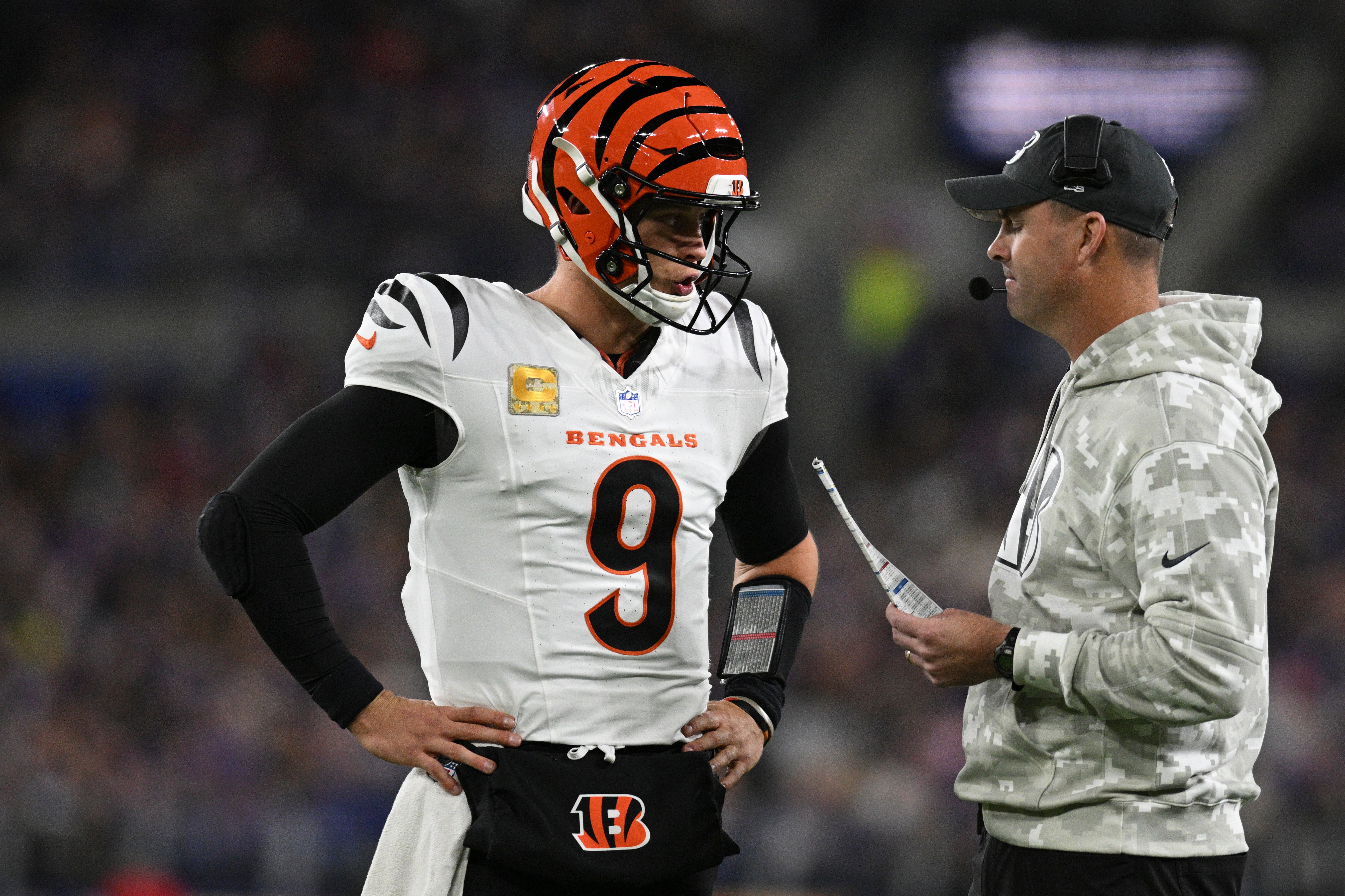 Nov 7, 2024; Baltimore, Maryland, USA; Cincinnati Bengals quarterback Joe Burrow (9) speaks with Cincinnati Bengals head coach Zac Taylor during the first quarter against the Baltimore Ravens at M&T Bank Stadium.